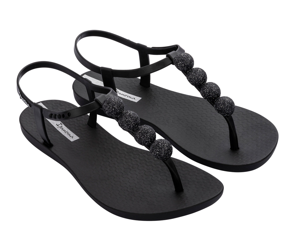 Angled view of a pair of black Ipanema Disco sandals with straps and 4 glitter balls on top strap.