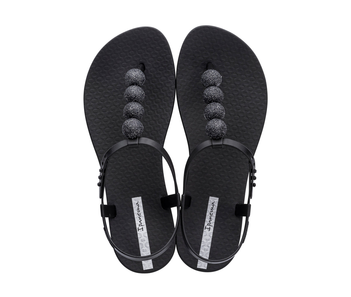 Top view of a pair of black Ipanema Disco sandals with straps and 4 glitter balls on top strap.