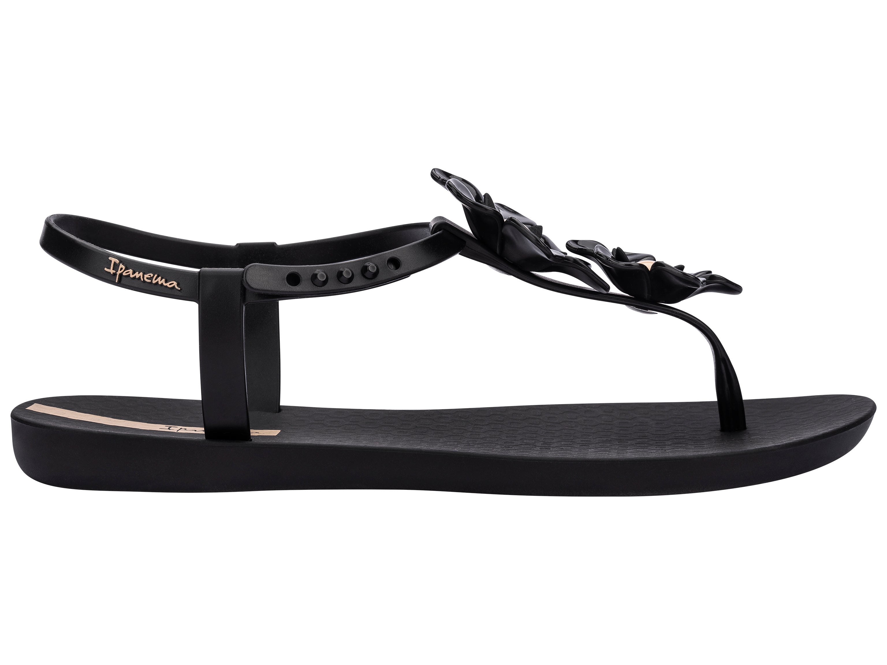 Outer side view of a black Ipanema Duo Flowers women's t-strap sandal with two flowers.