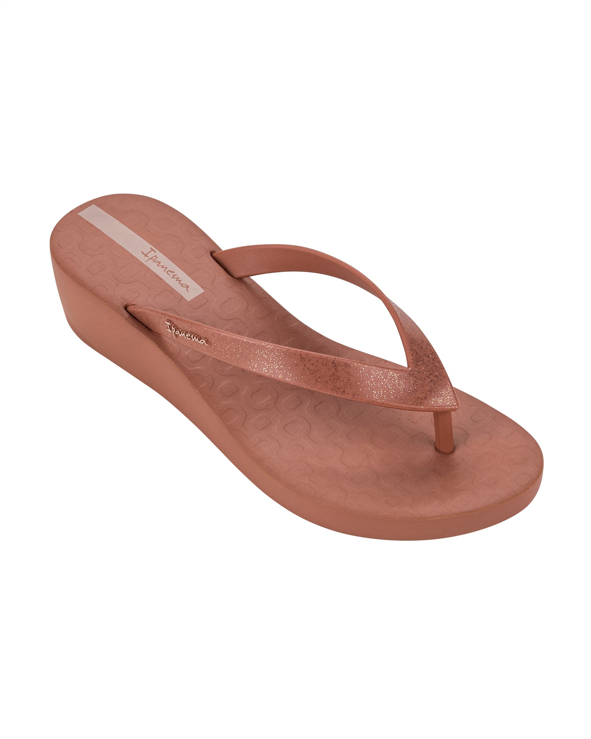 Angled view of a pink Ipanema Selfie women's wedge flip flop with glitter pink straps.