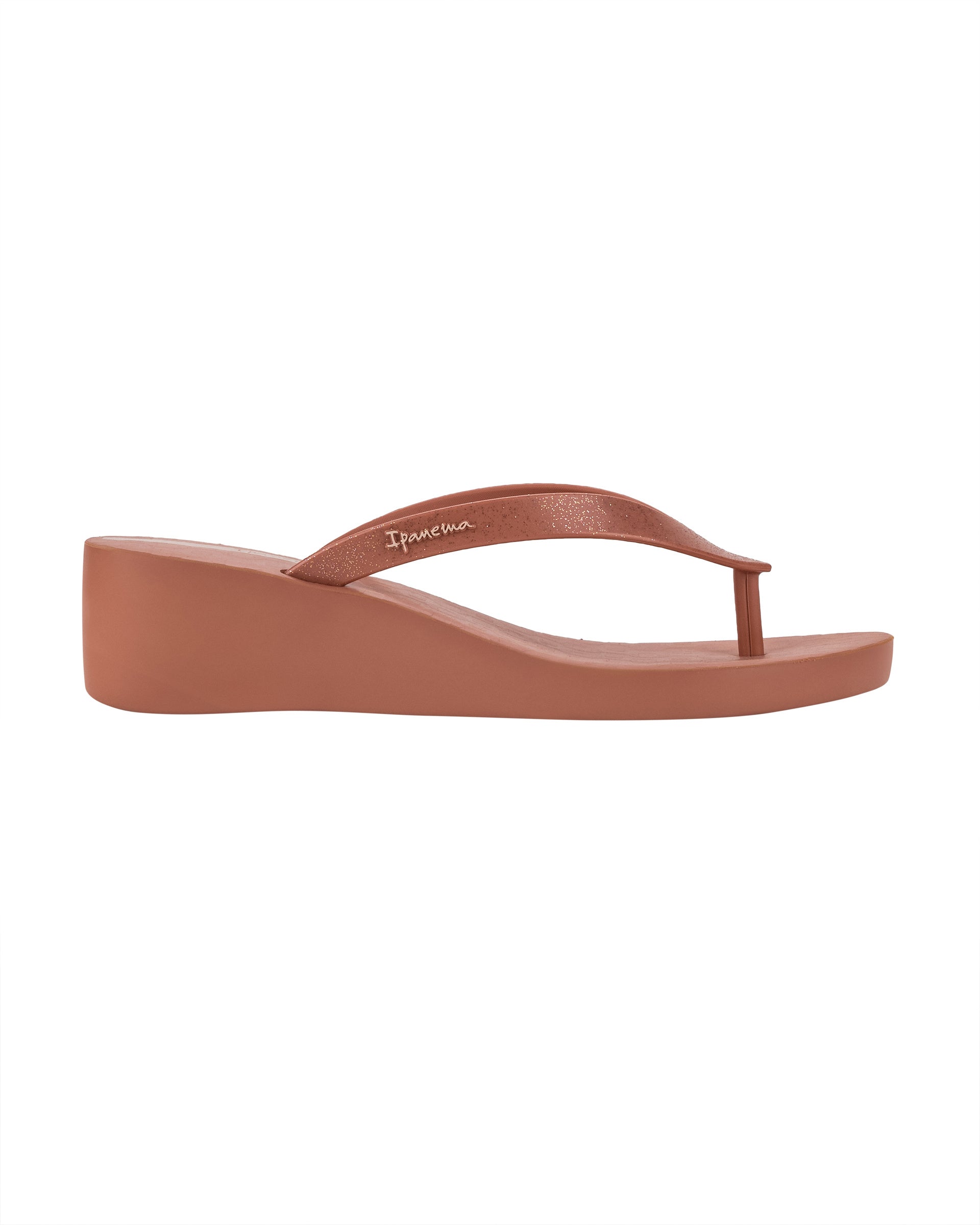 Outer side view of a pink Ipanema Selfie women's wedge flip flop with glitter pink straps.