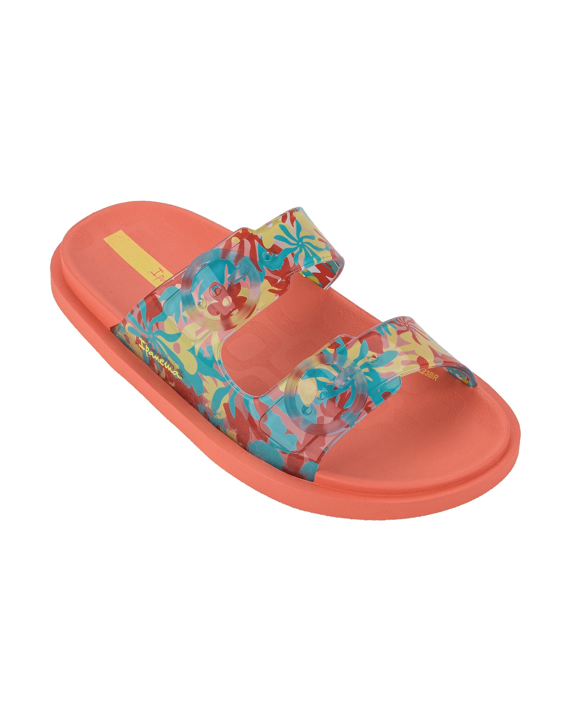 Angled view of a orange Ipanema Follow kids slide with floral print on the upper.