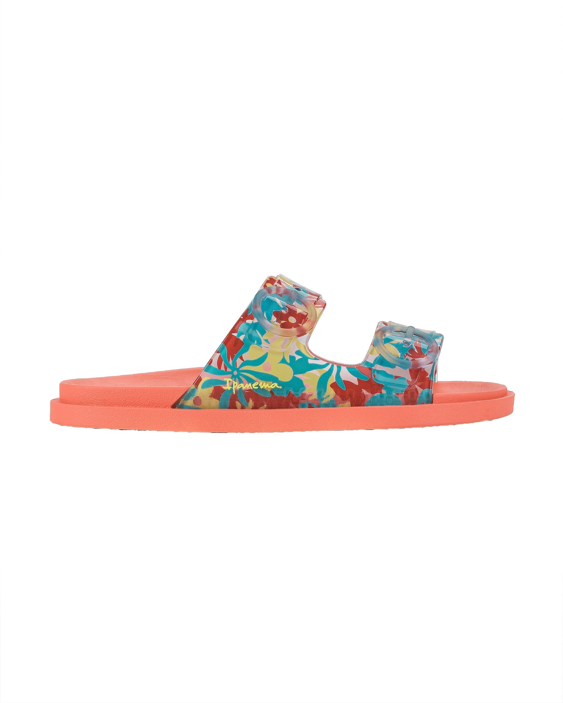Outer side view of a orange Ipanema Follow kids slide with floral print on the upper.