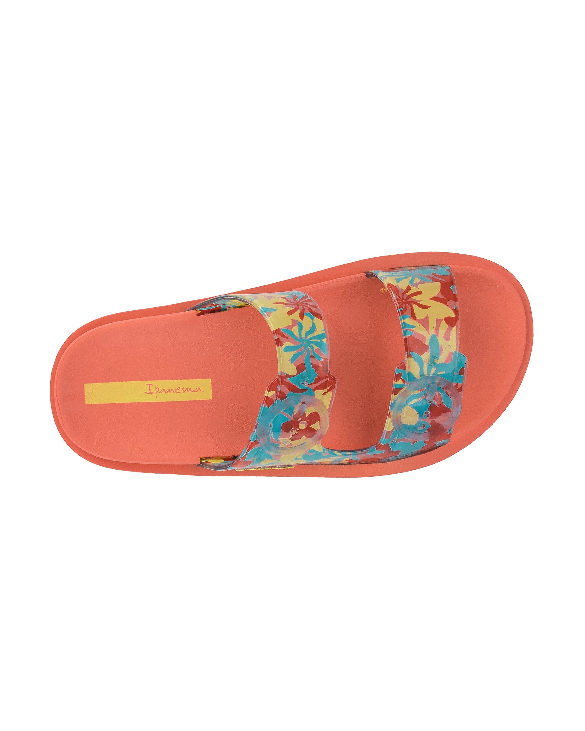 Top view of a orange Ipanema Follow kids slide with floral print on the upper.