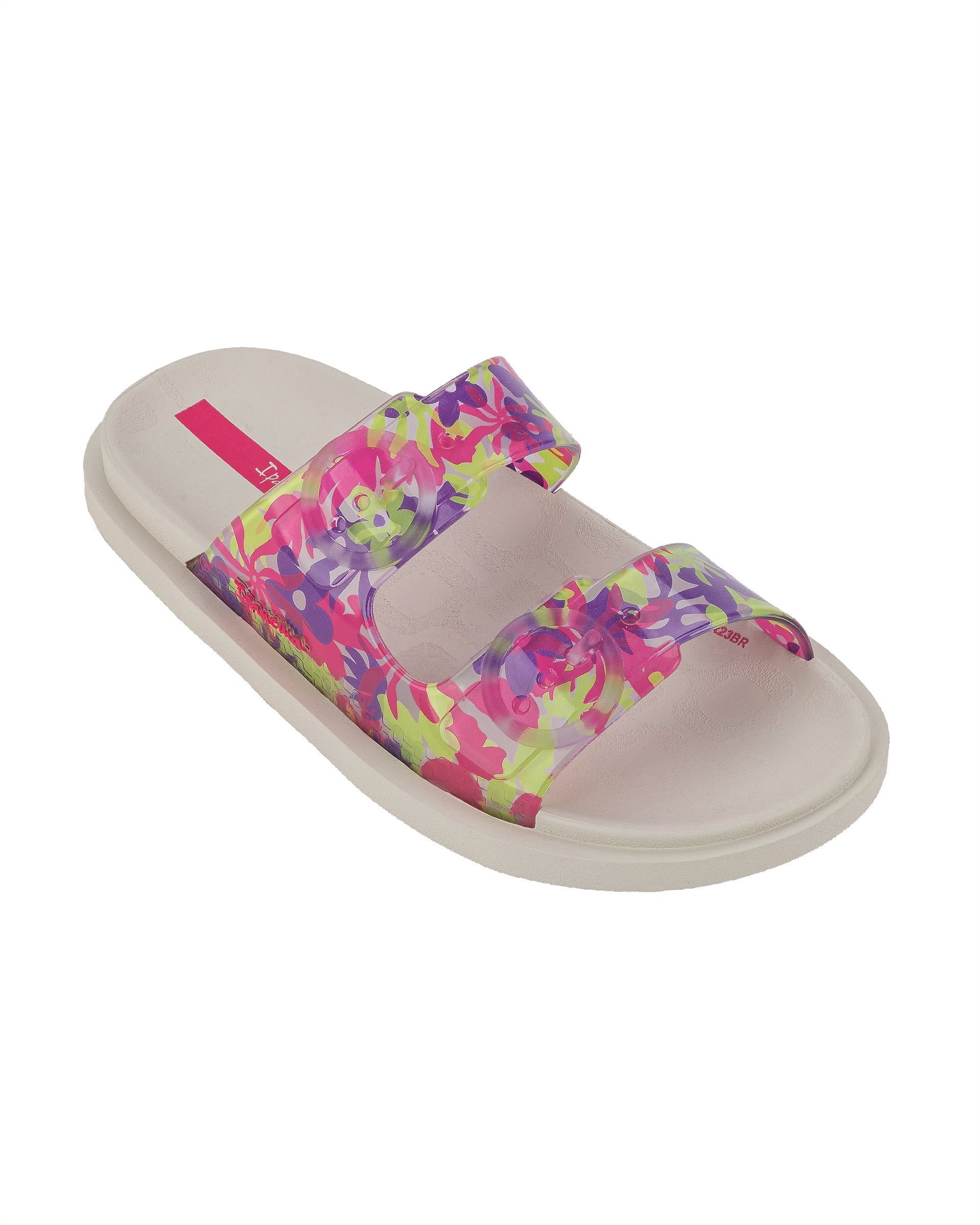 Angled view of a beige Ipanema Follow kids slide with floral print on the upper.