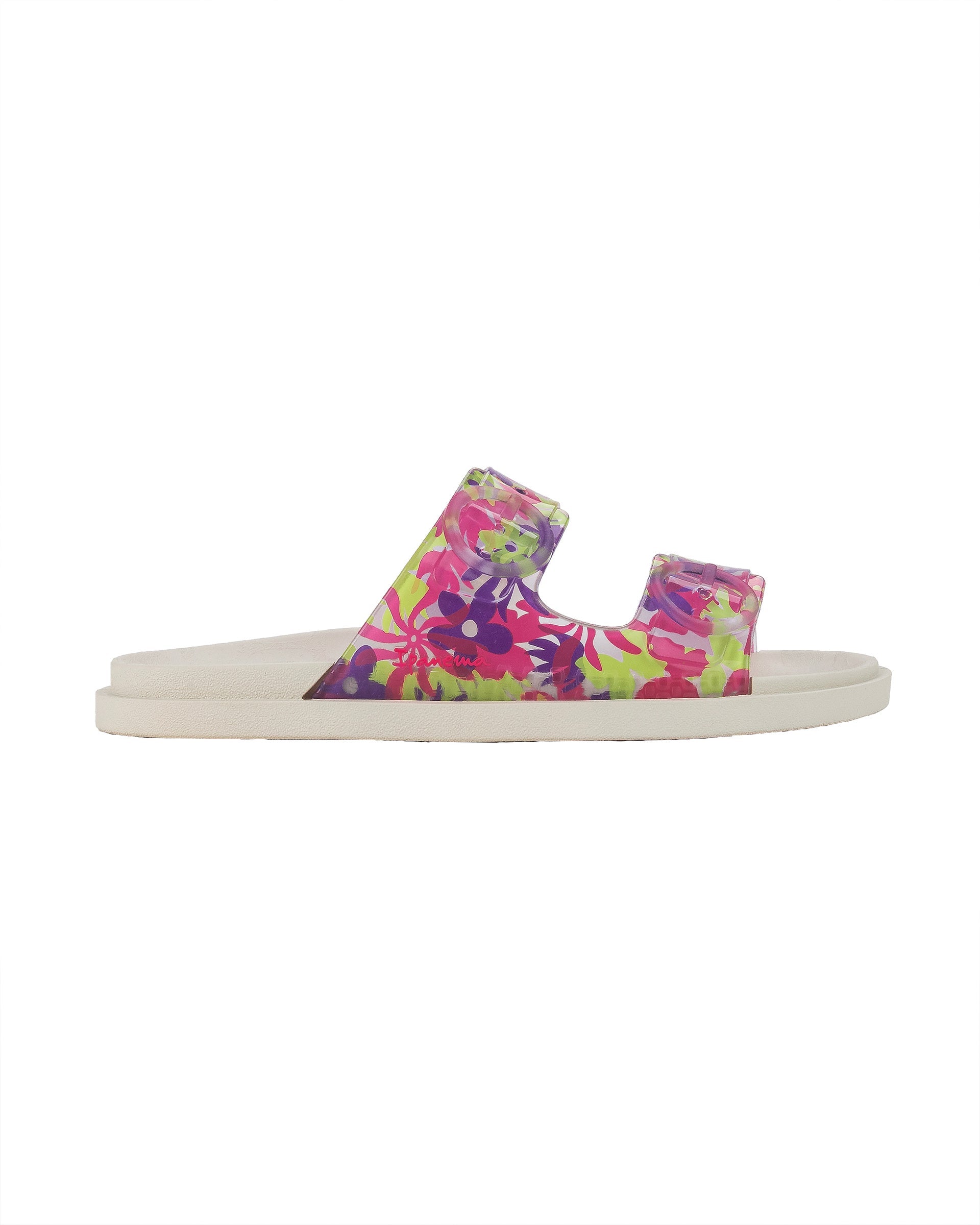 Outer side view of a beige Ipanema Follow kids slide with floral print on the upper.