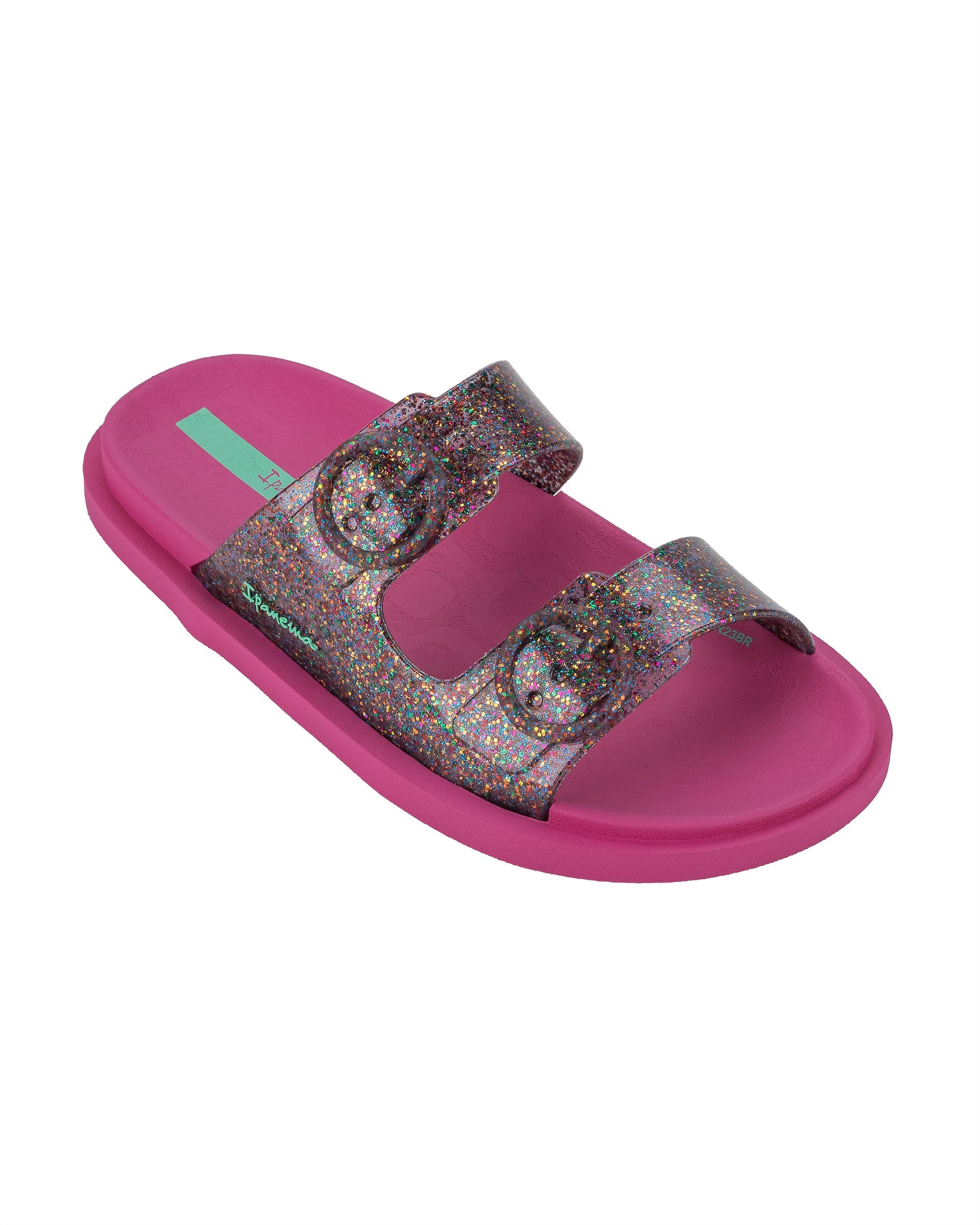 Angled view of a pink Ipanema Follow kids slide with a multicolor glitter upper.