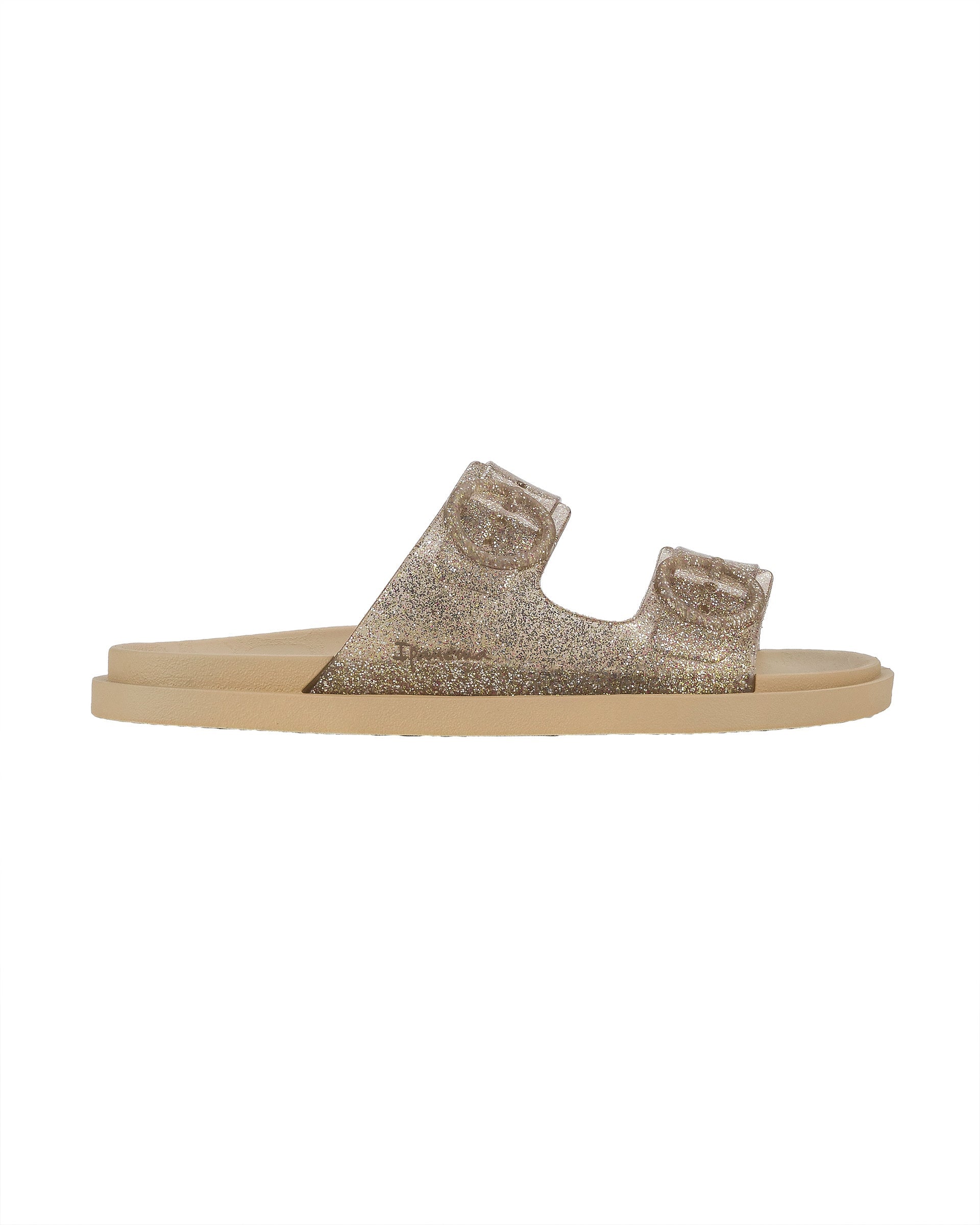 Outer side view of a beige Ipanema Follow kids slide with a glitter upper.