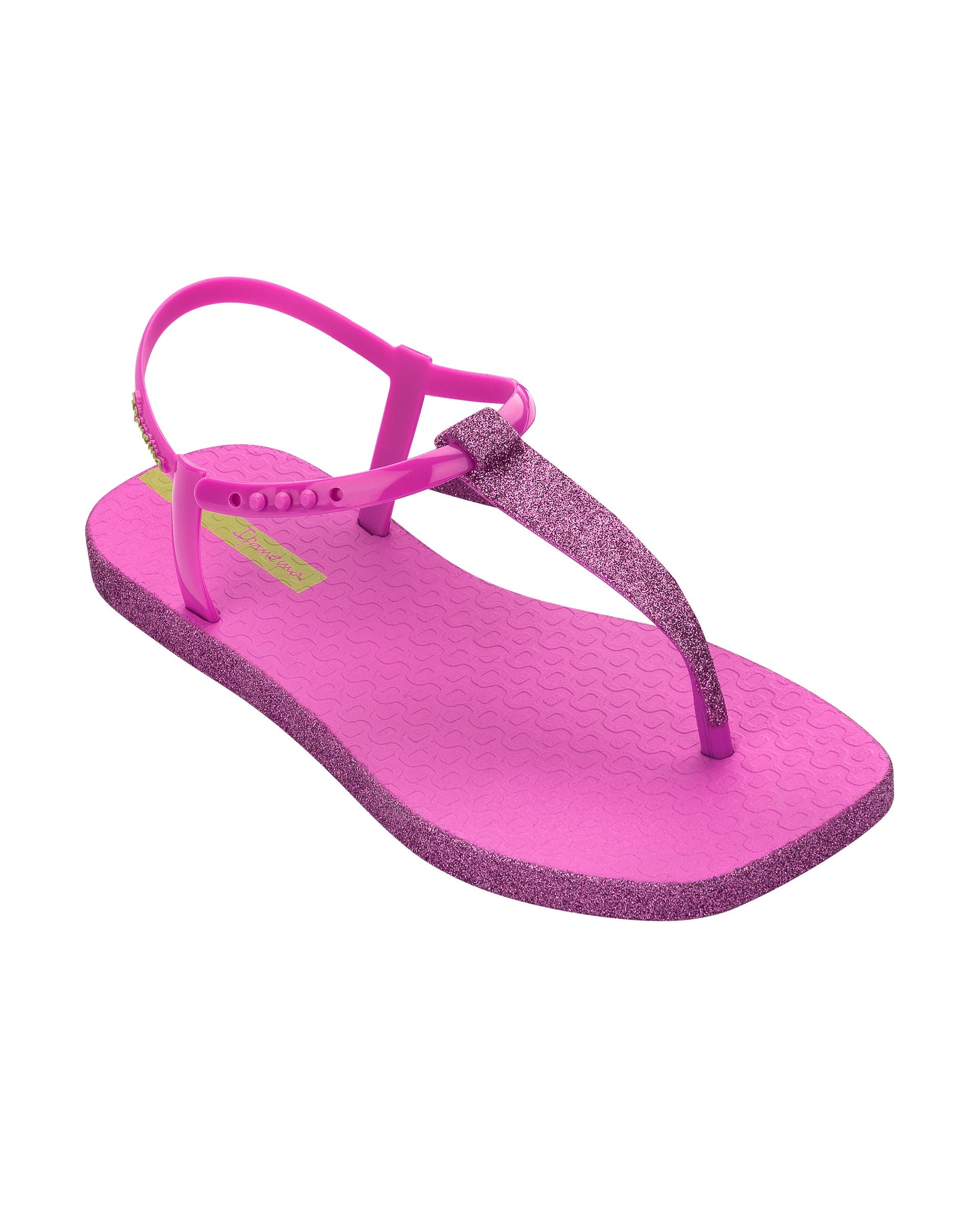 Angled view of a pink Ipanema Class Edge Glow t-strap women's sandal with glitter pink thong.