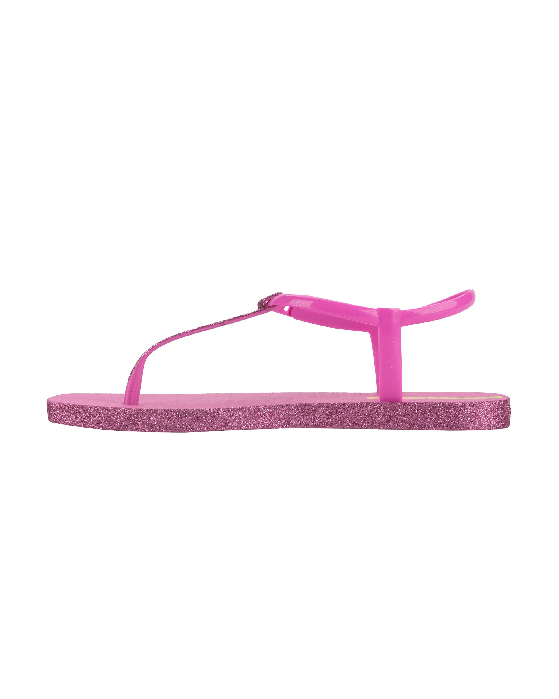Inner side view of a pink Ipanema Class Edge Glow t-strap women's sandal with glitter pink thong.