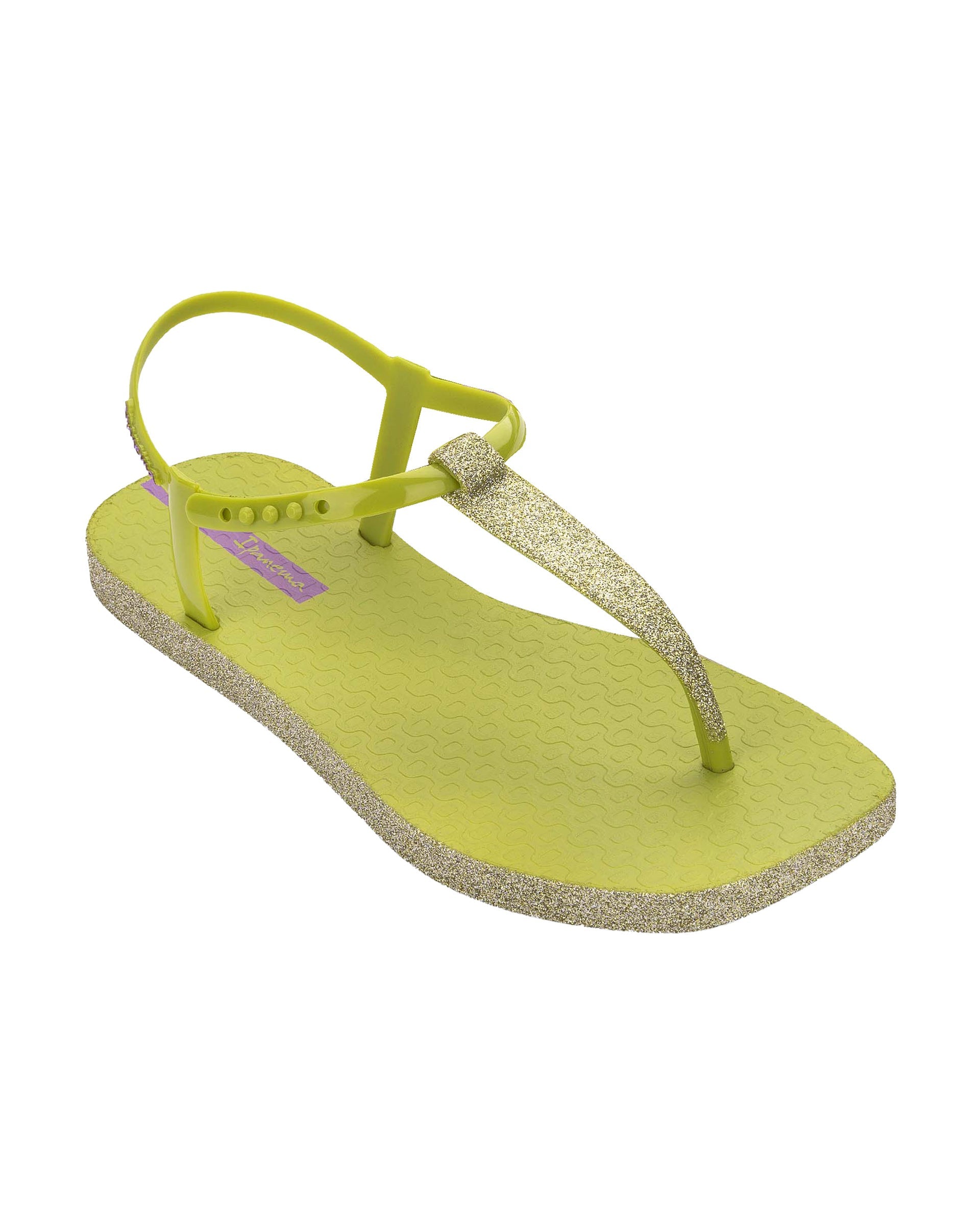 Angled view of a green Ipanema Class Edge Glow t-strap women's sandal with glitter green thong.