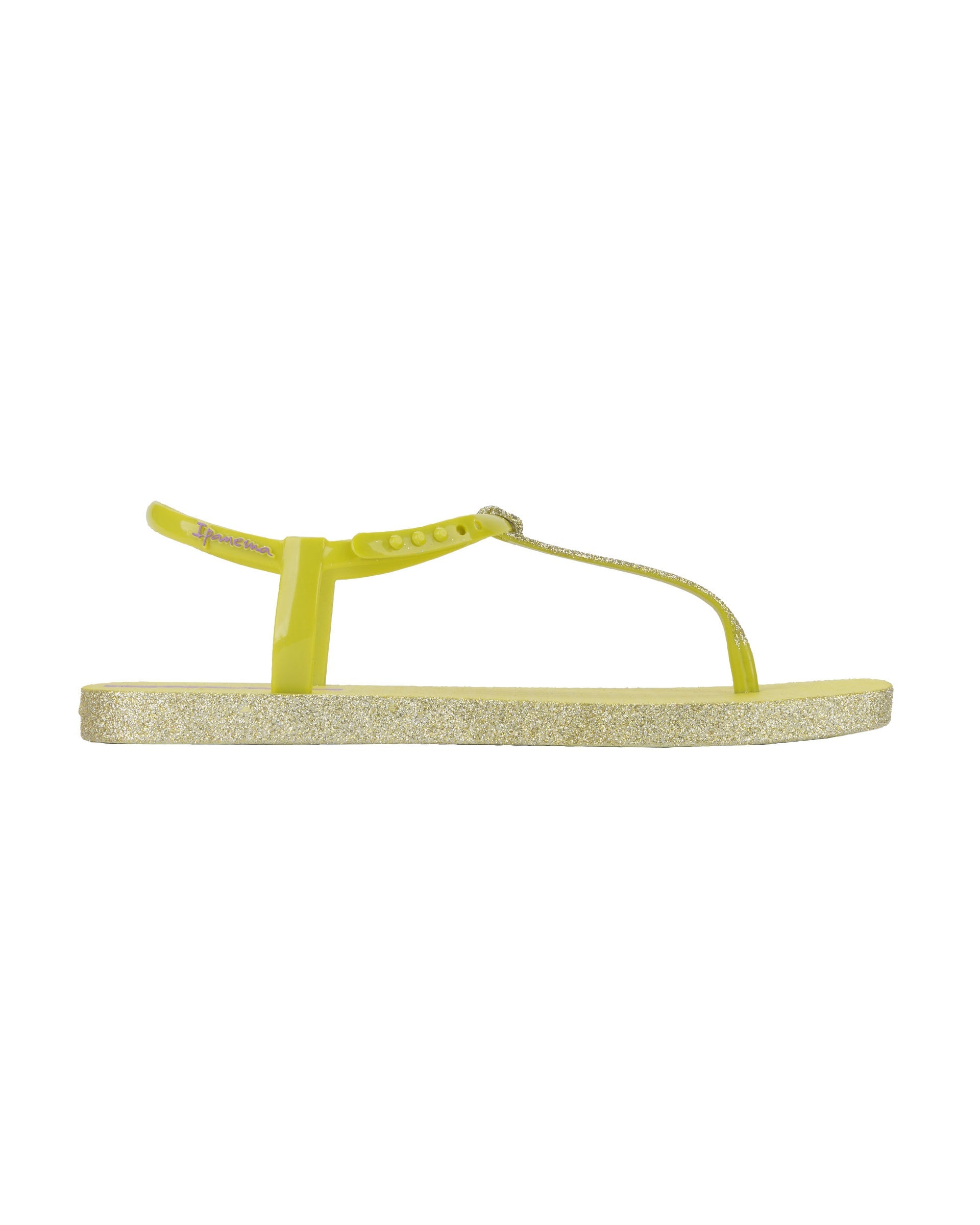 Outer side view of a green Ipanema Class Edge Glow t-strap women's sandal with glitter green thong.