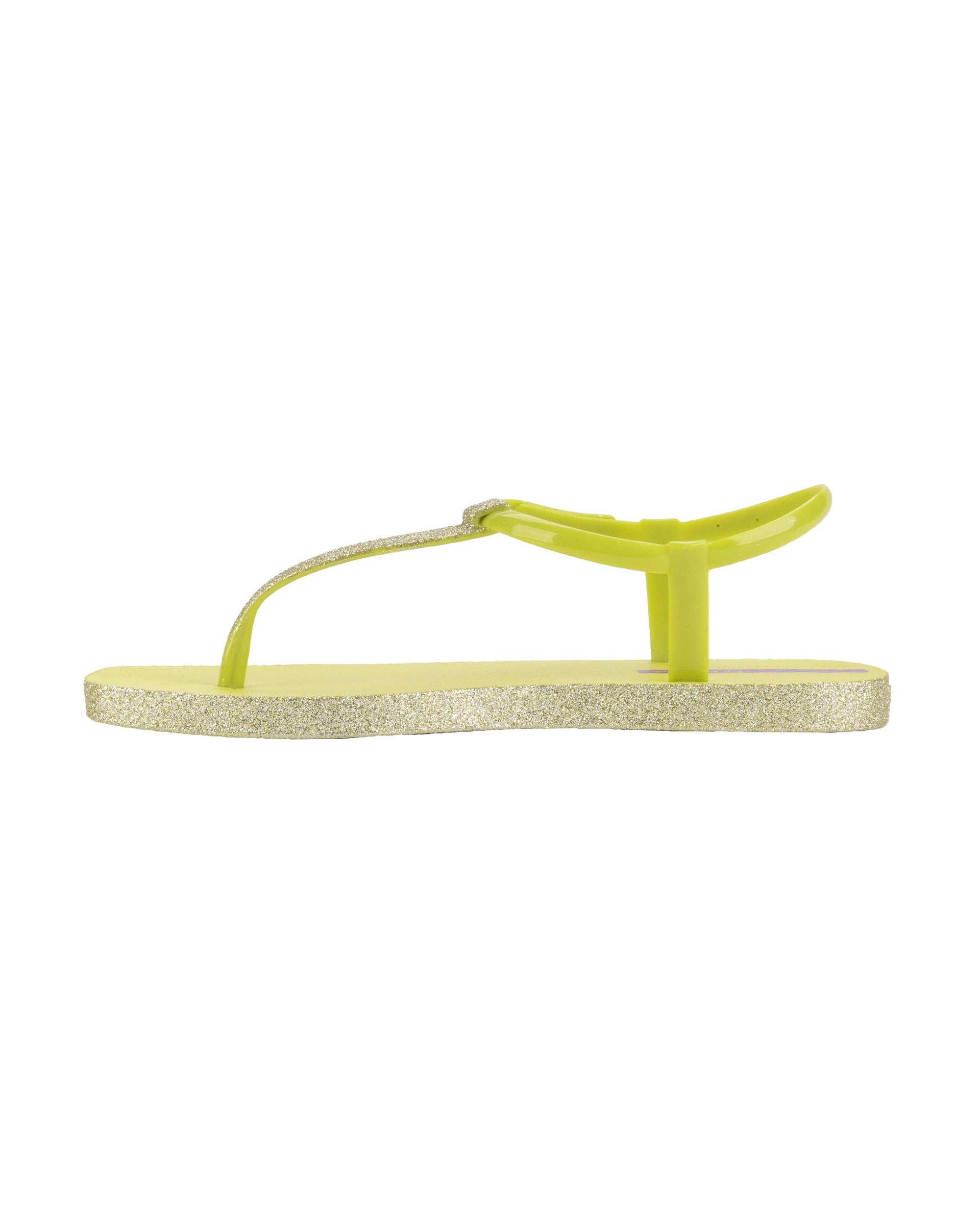 Inner side view of a green Ipanema Class Edge Glow t-strap women's sandal with glitter green thong.