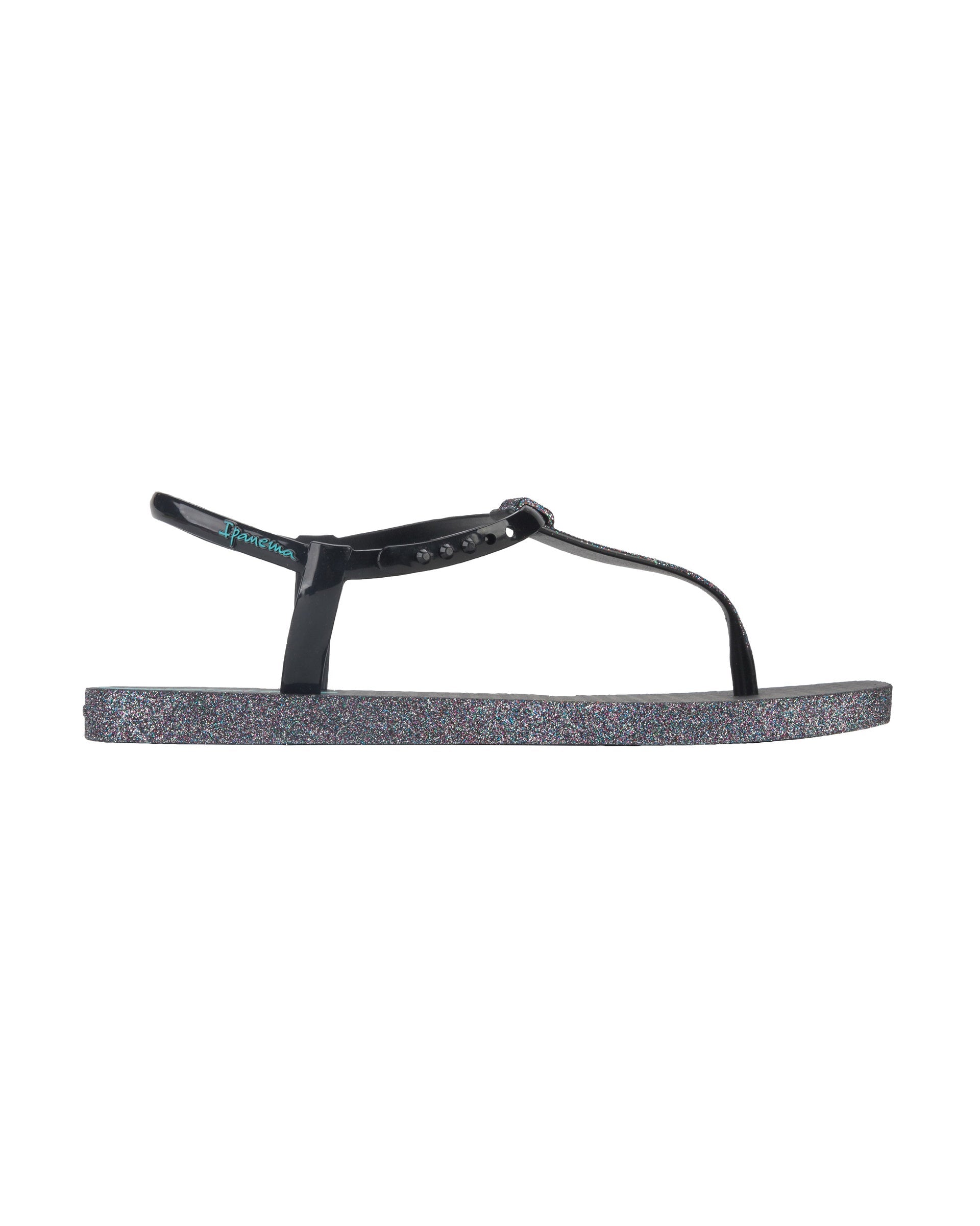 Outer side view of a black Ipanema Class Edge Glow t-strap women's sandal with glitter black thong.