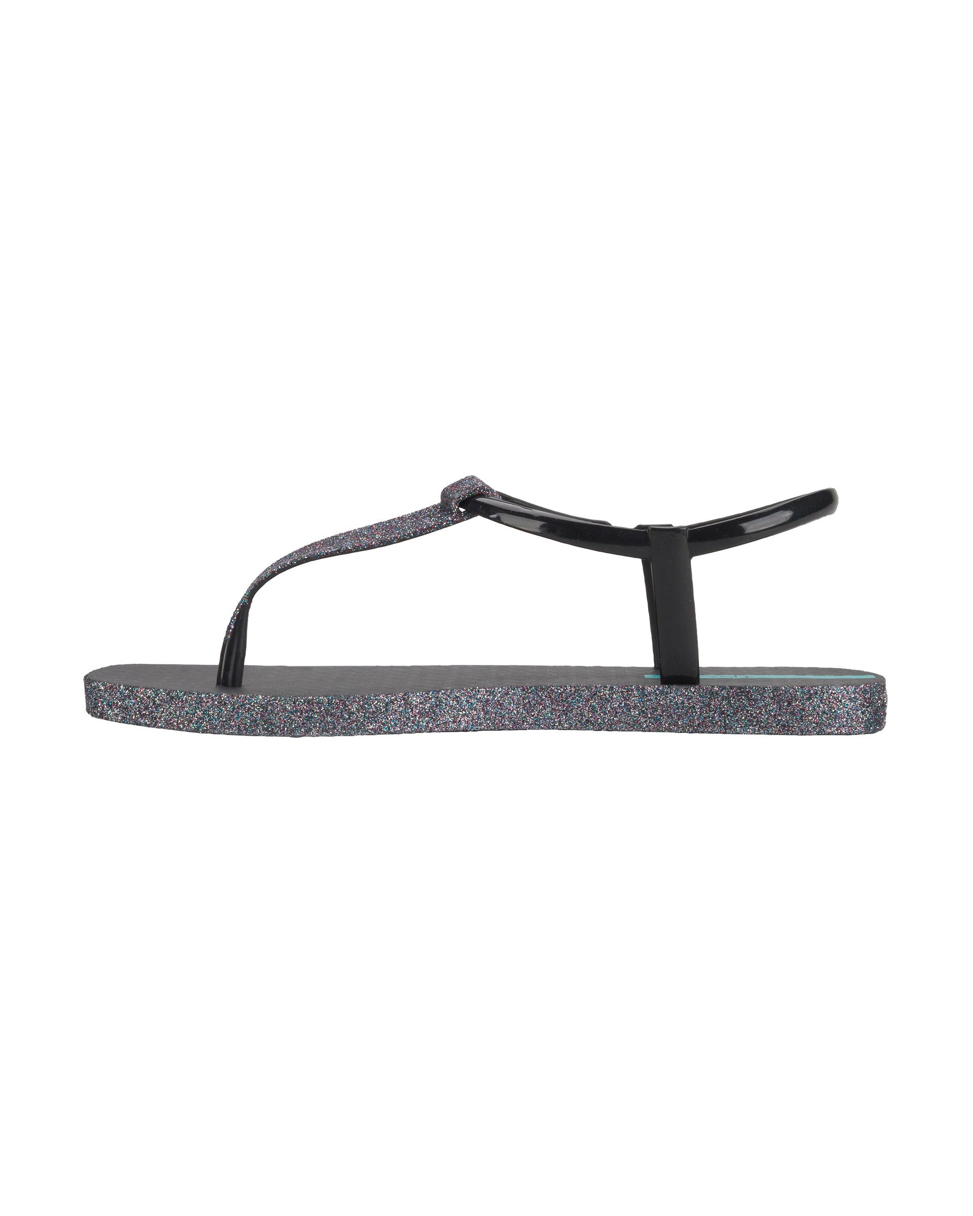 Inner side view of a black Ipanema Class Edge Glow t-strap women's sandal with glitter black thong.