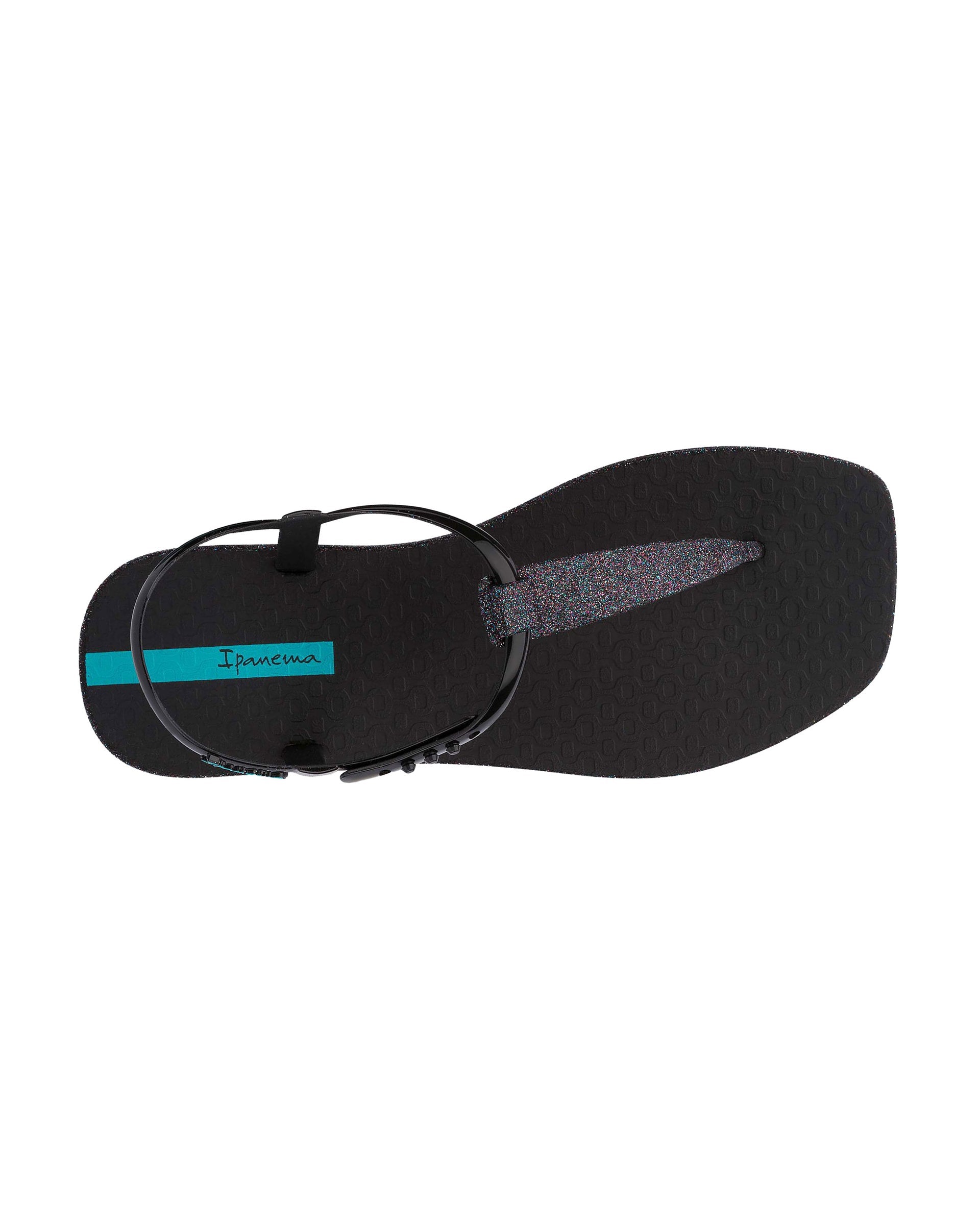 Top view of a black Ipanema Class Edge Glow t-strap women's sandal with glitter black thong.