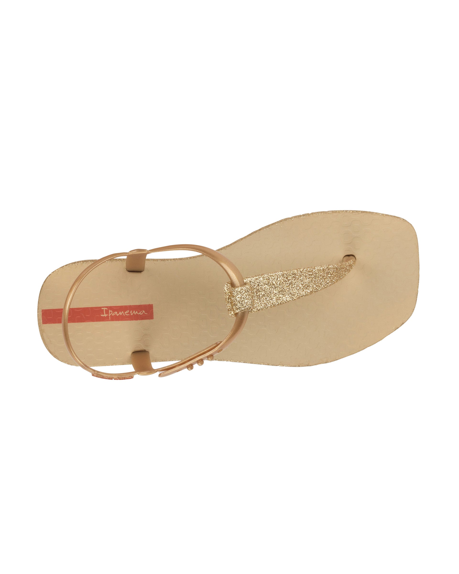 Top view of a beige Ipanema Class Edge Glow t-strap women's sandal with gold strap and glitter thong.