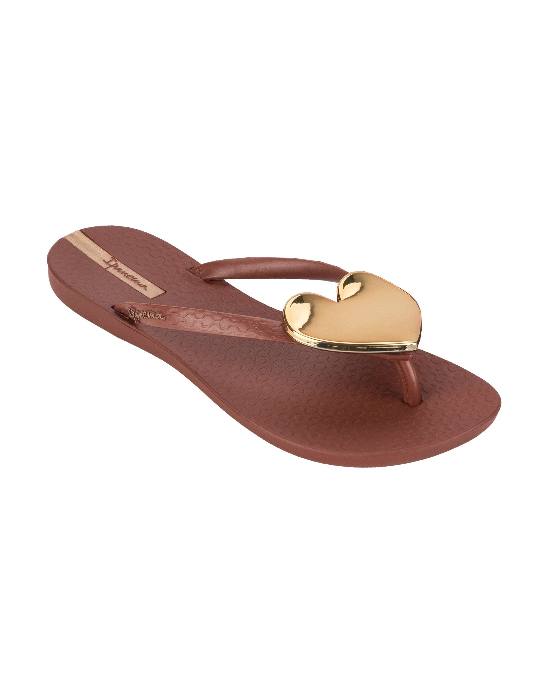 Angled view of a brown Ipanema Wave Heart women's flip flop with gold heart.