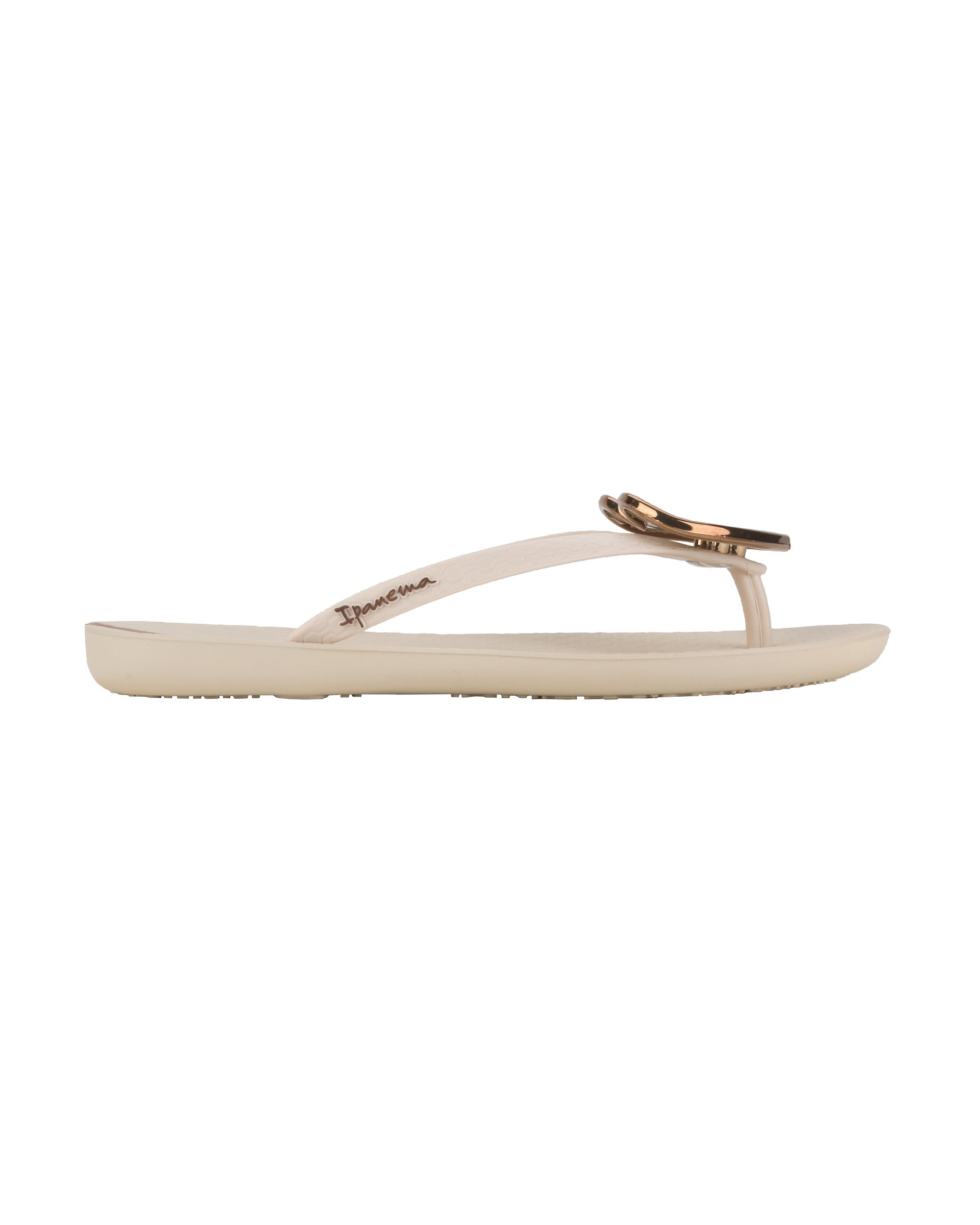 Outer side view of a beige Ipanema Wave Heart women's flip flop with bronze heart.