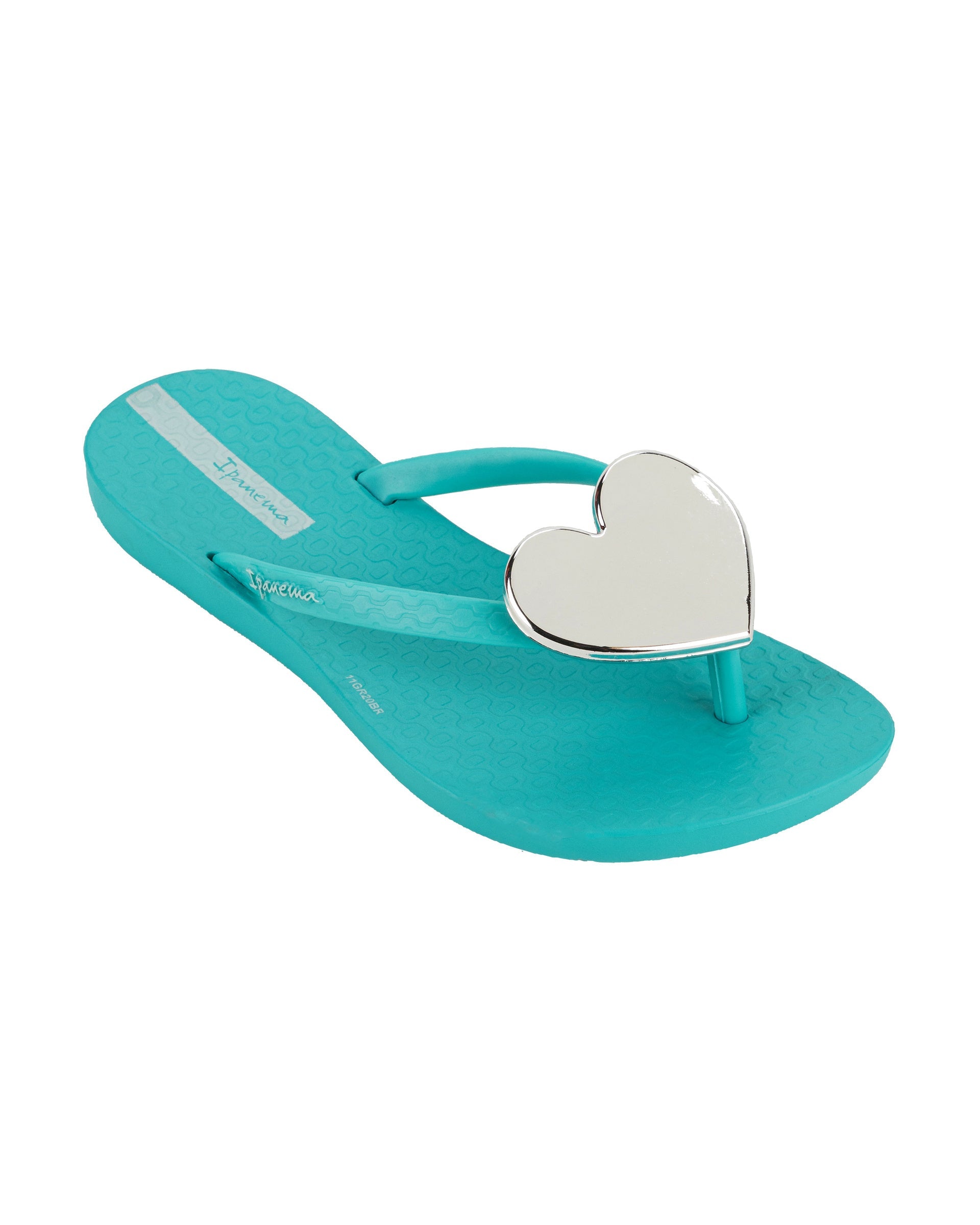 Angled view of a blue Ipanema Wave Heart kids flip flop with silver decorative heart on the upper.