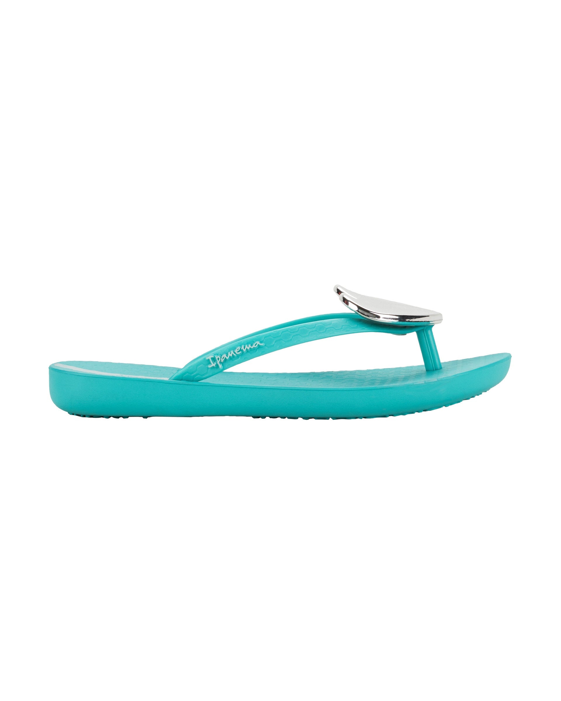 Outer side view of a blue Ipanema Wave Heart kids flip flop with silver decorative heart on the upper.