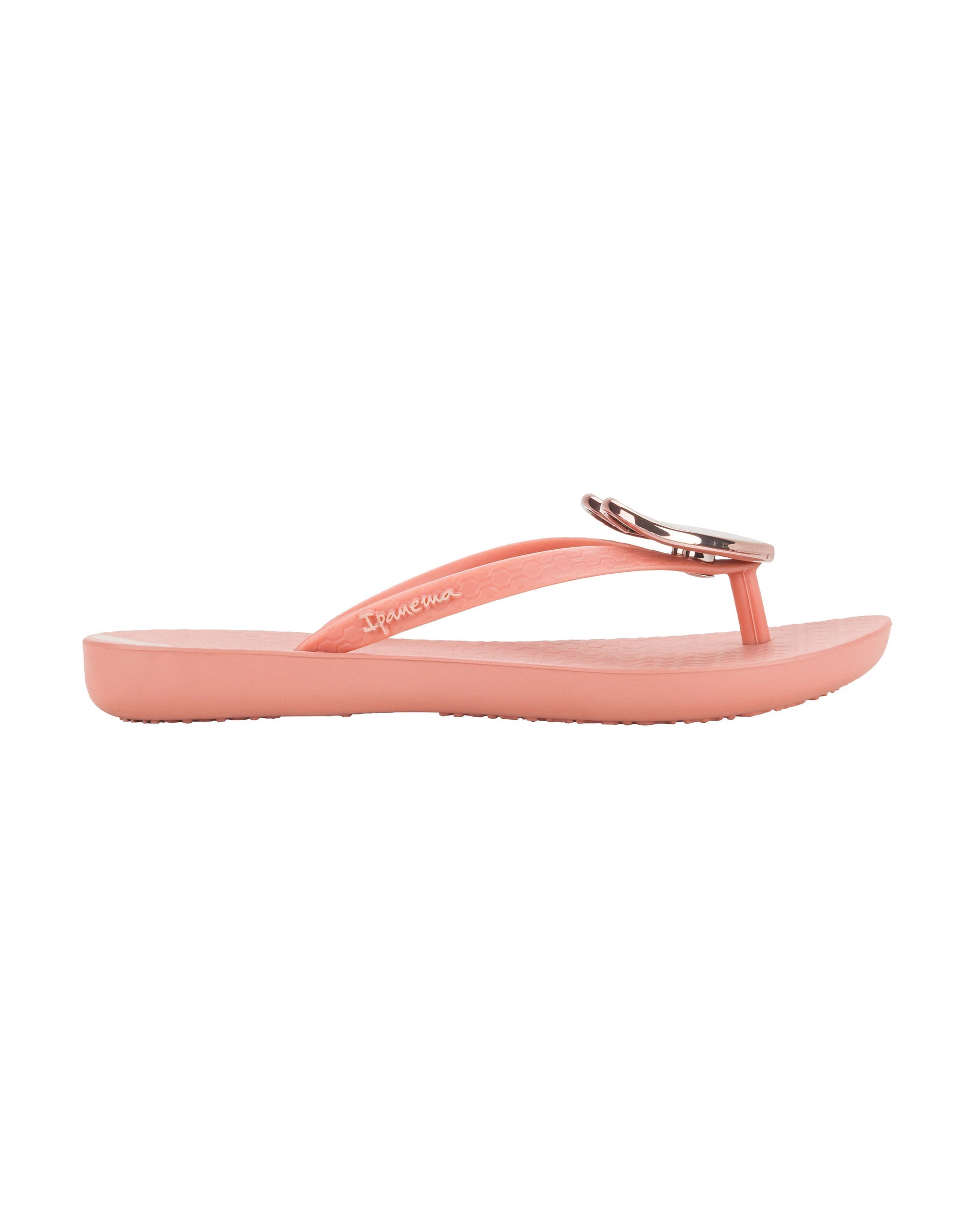 Outer view  of a pink Ipanema Wave Heart kids flip flop with rose gold decorative heart on the upper.