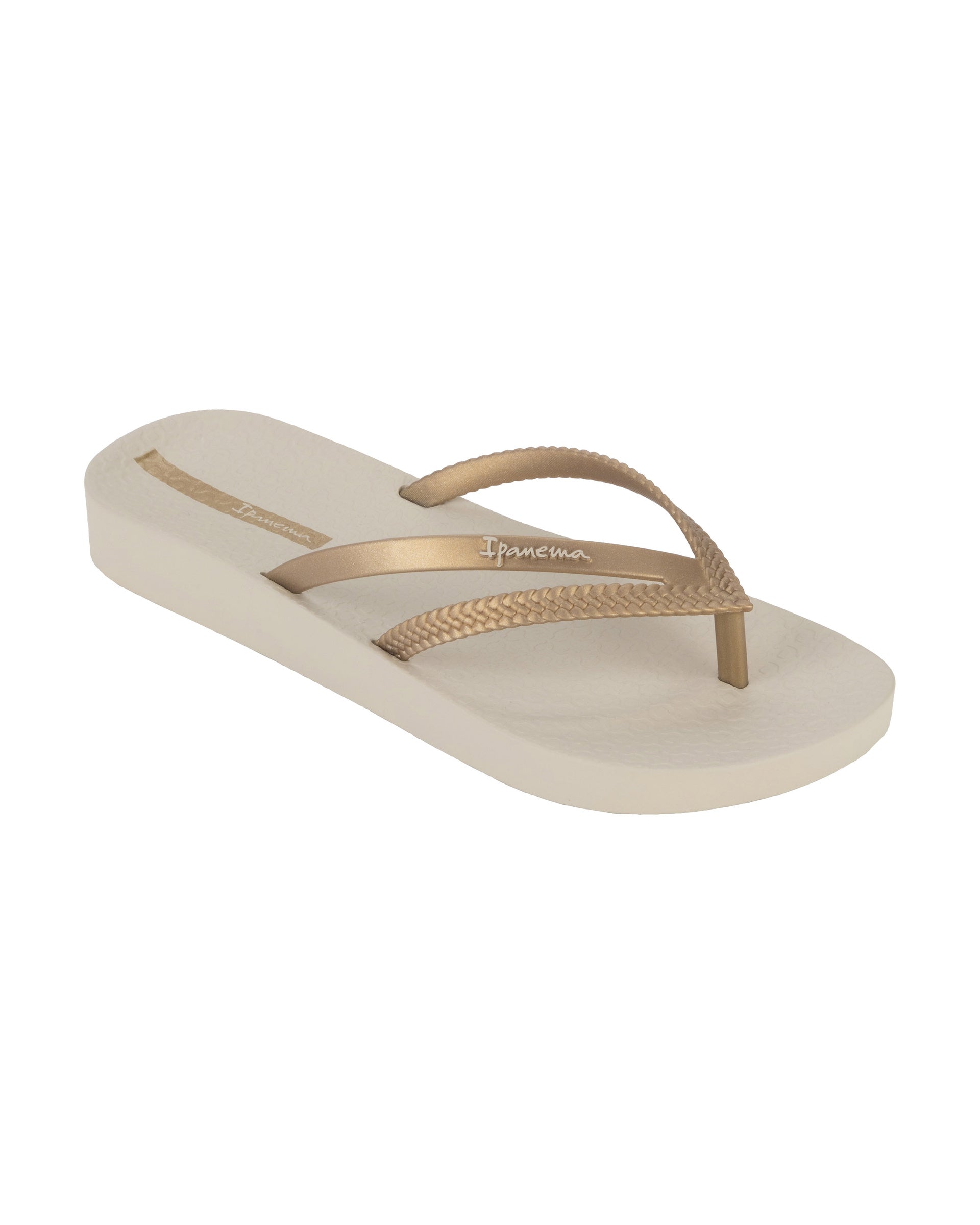 Angled view of a beige Ipanema Bossa Soft women's flip flop with gold straps.