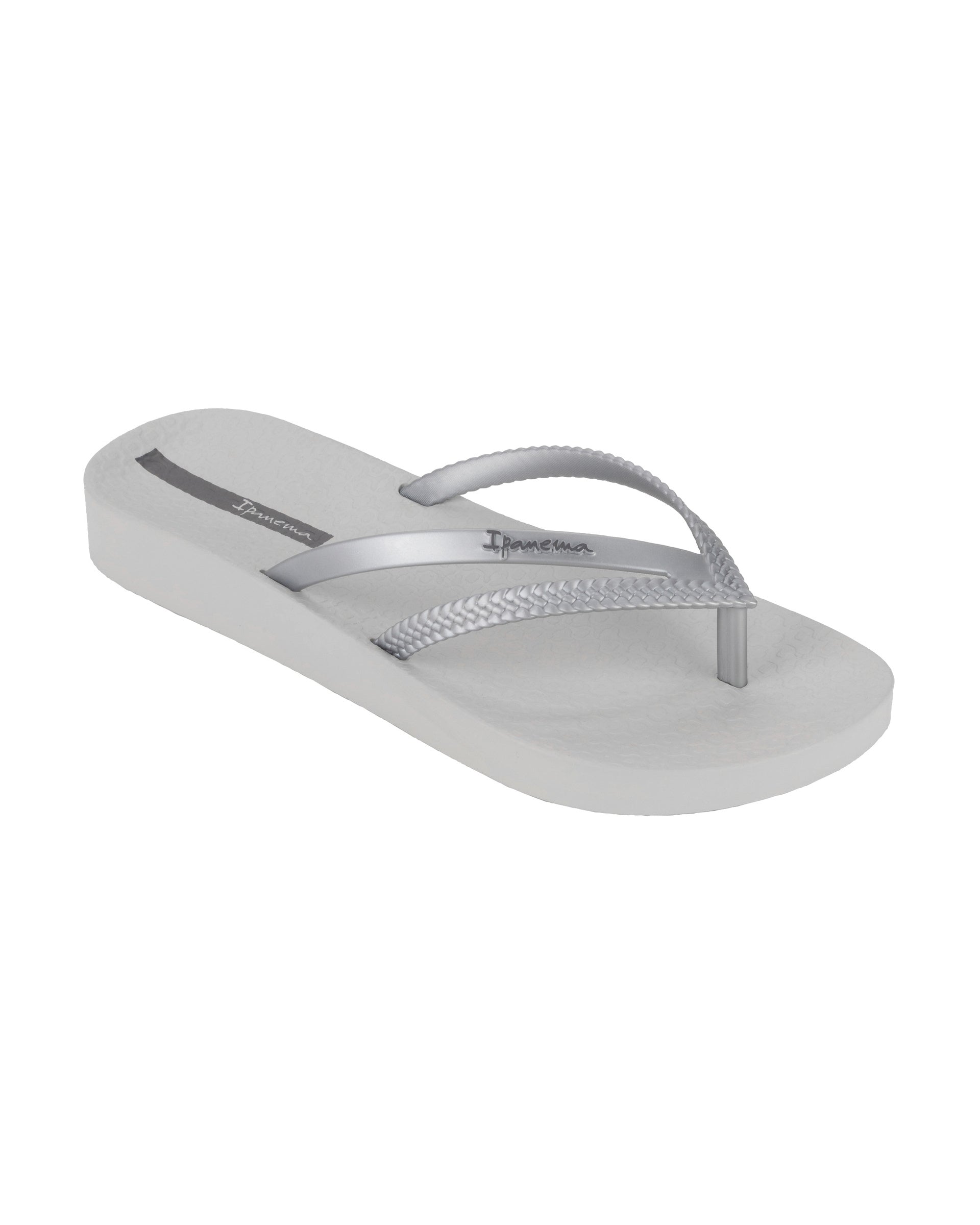 Angled view of a grey Ipanema Bossa Soft women's flip flop with metallic grey straps.