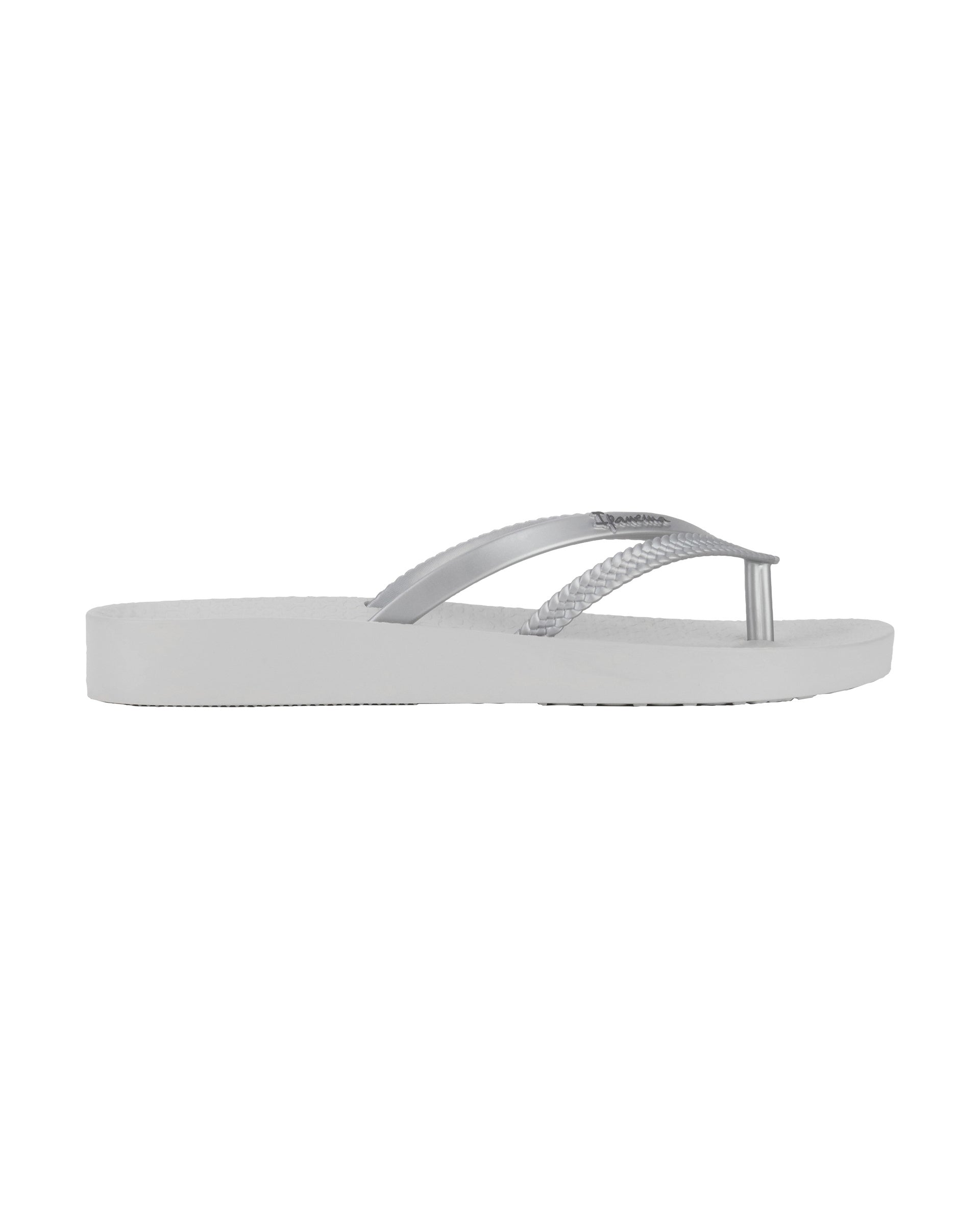Outer side view of a grey Ipanema Bossa Soft women's flip flop with metallic grey straps.