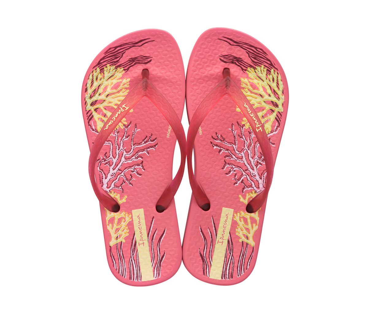 Top view of a pair of pink Ipanema Ana Glossy flip flop kids with an under the sea print on the footbed.
