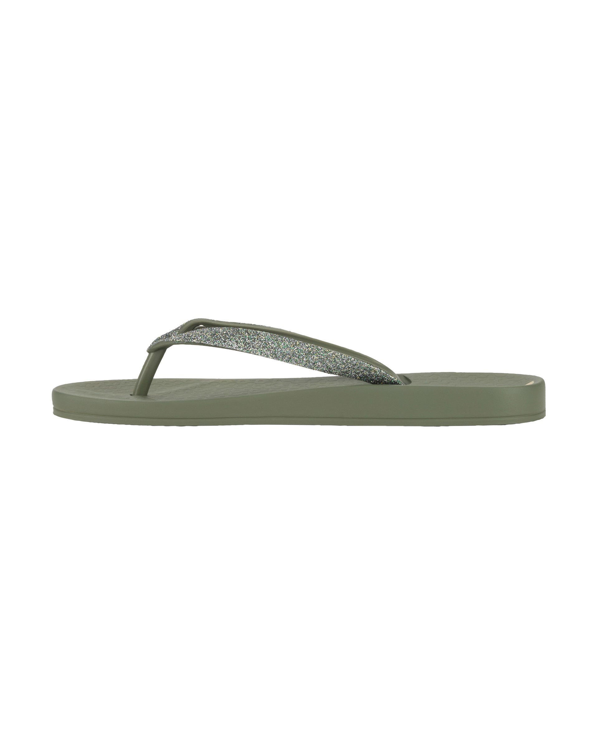 Inner side view of a green Ipanema Ana Sparkle women's flip flop with glitter green straps.