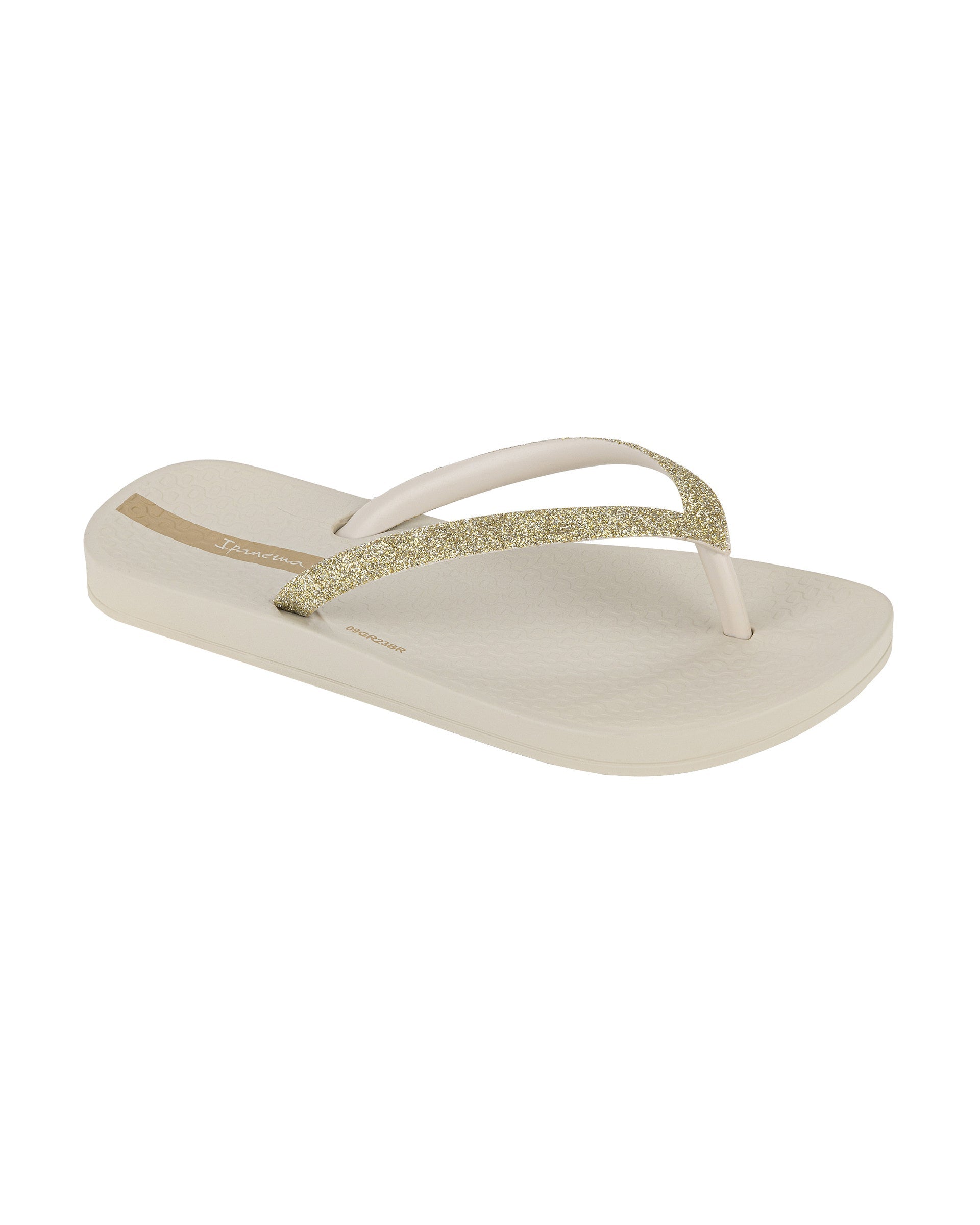 Angled view of a beige Ipanema Ana Sparkle kids flip flop with gold glitter strap.