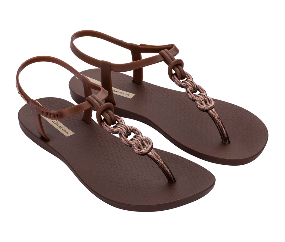 Angled view of a pair of brown Ipanema Connect sandals with a bronze chain inspired t-strap.