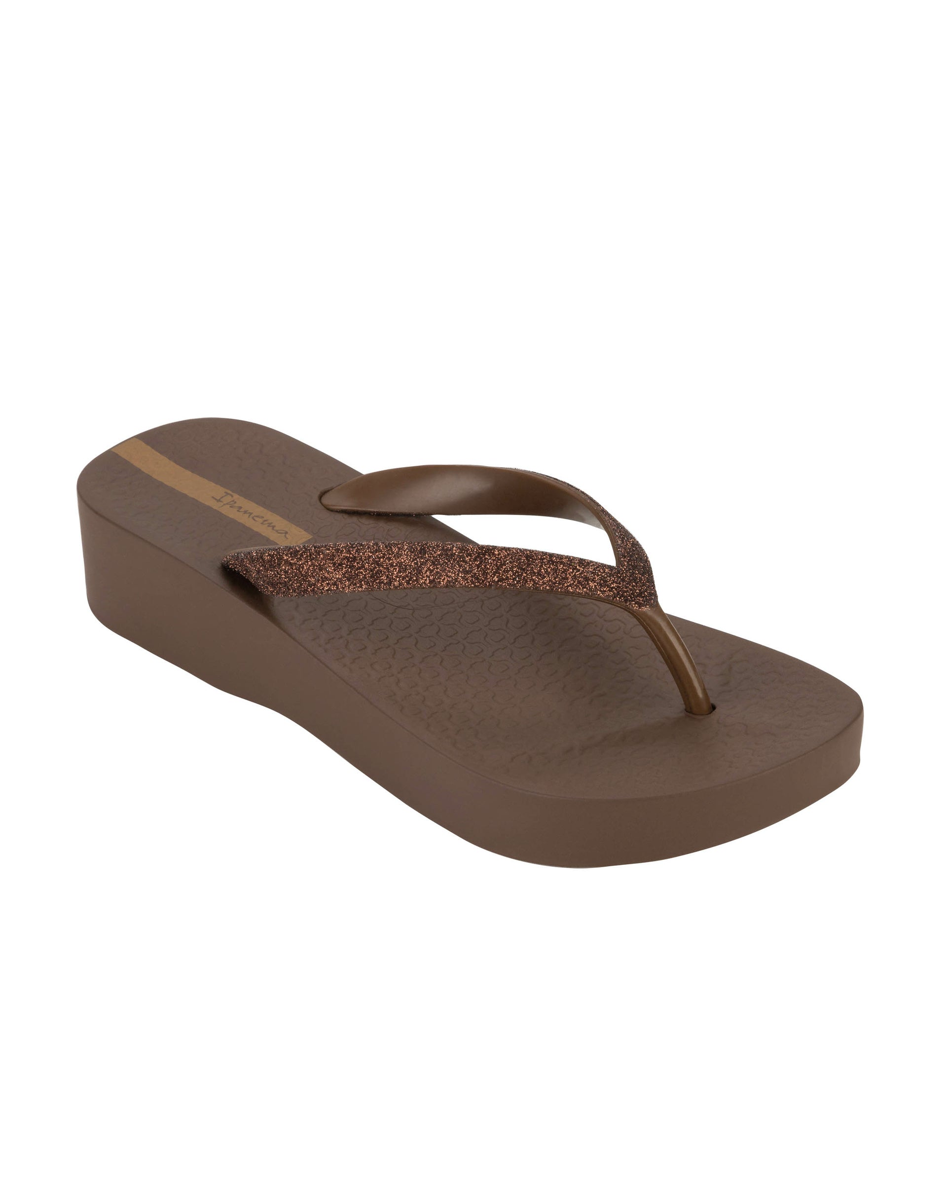 Angled view of a brown Ipanema Mesh Chic women's wedge flip flop with glitter brown straps.