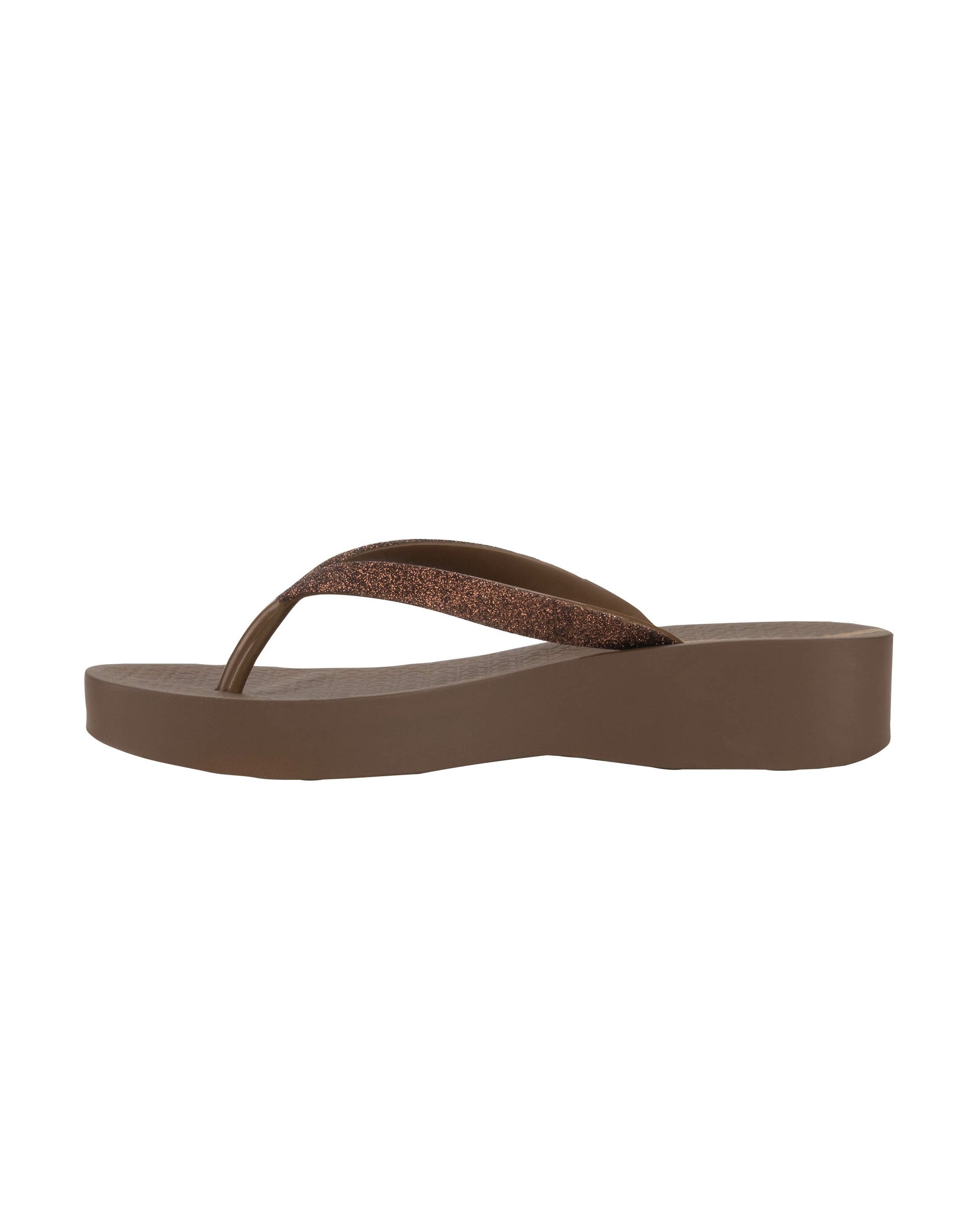 Inner side view of a brown Ipanema Mesh Chic women's wedge flip flop with glitter brown straps.