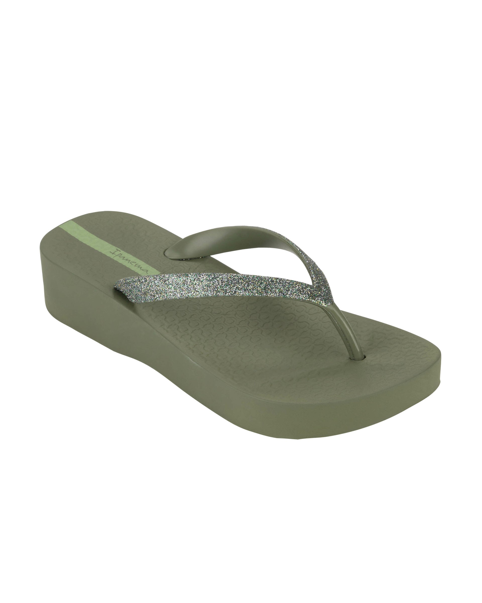 Angled view of a green Ipanema Mesh Chic women's wedge flip flop with glitter green straps.