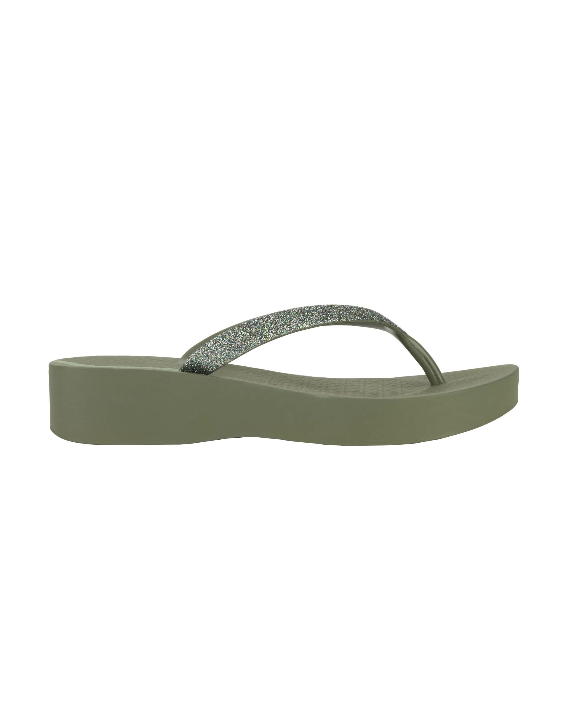 Outer side view of a green Ipanema Mesh Chic women's wedge flip flop with glitter green straps.