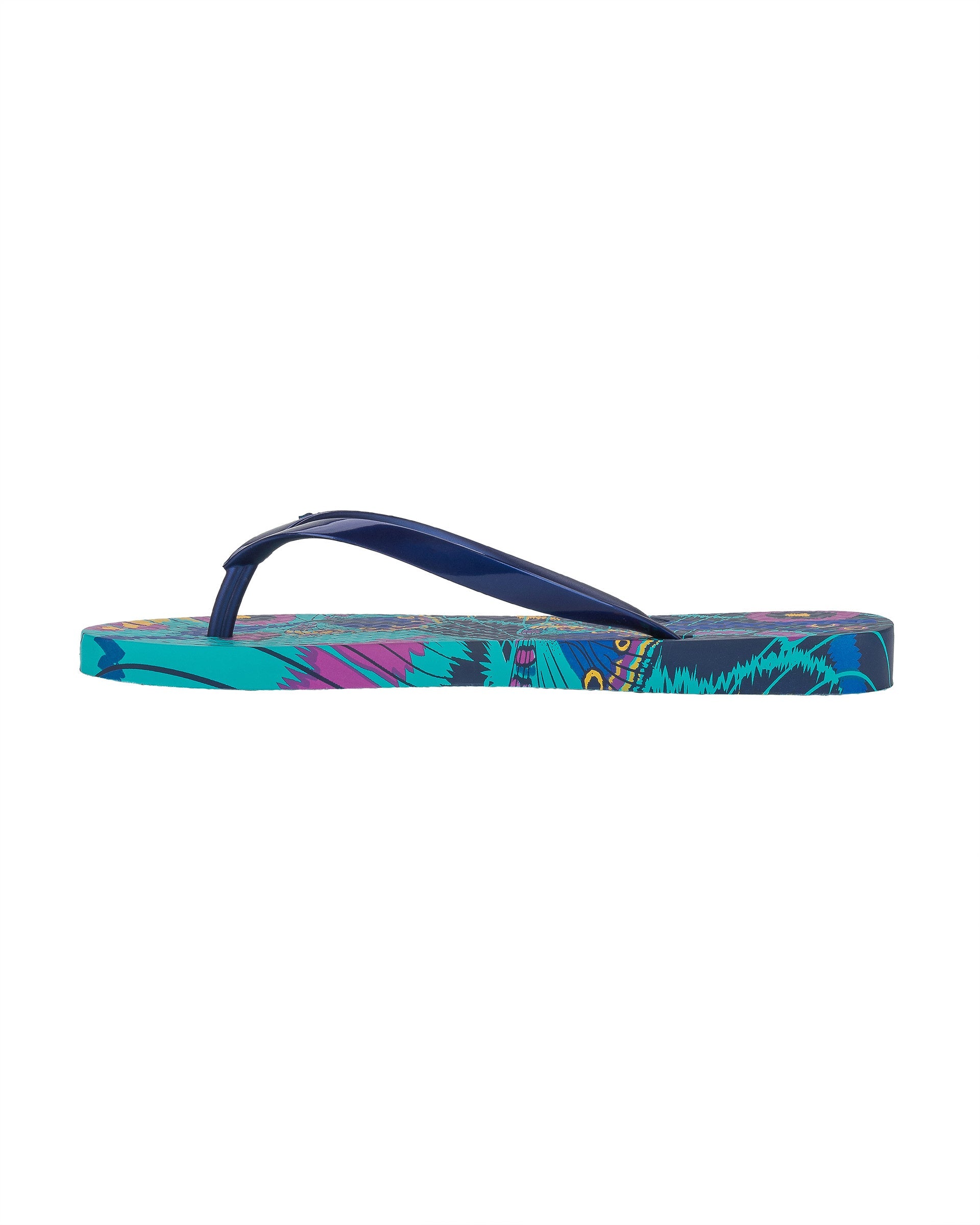 Inner side view of a blue Ipanema Animal Print women's flip flop with glitter blue straps and butterfly sole print.