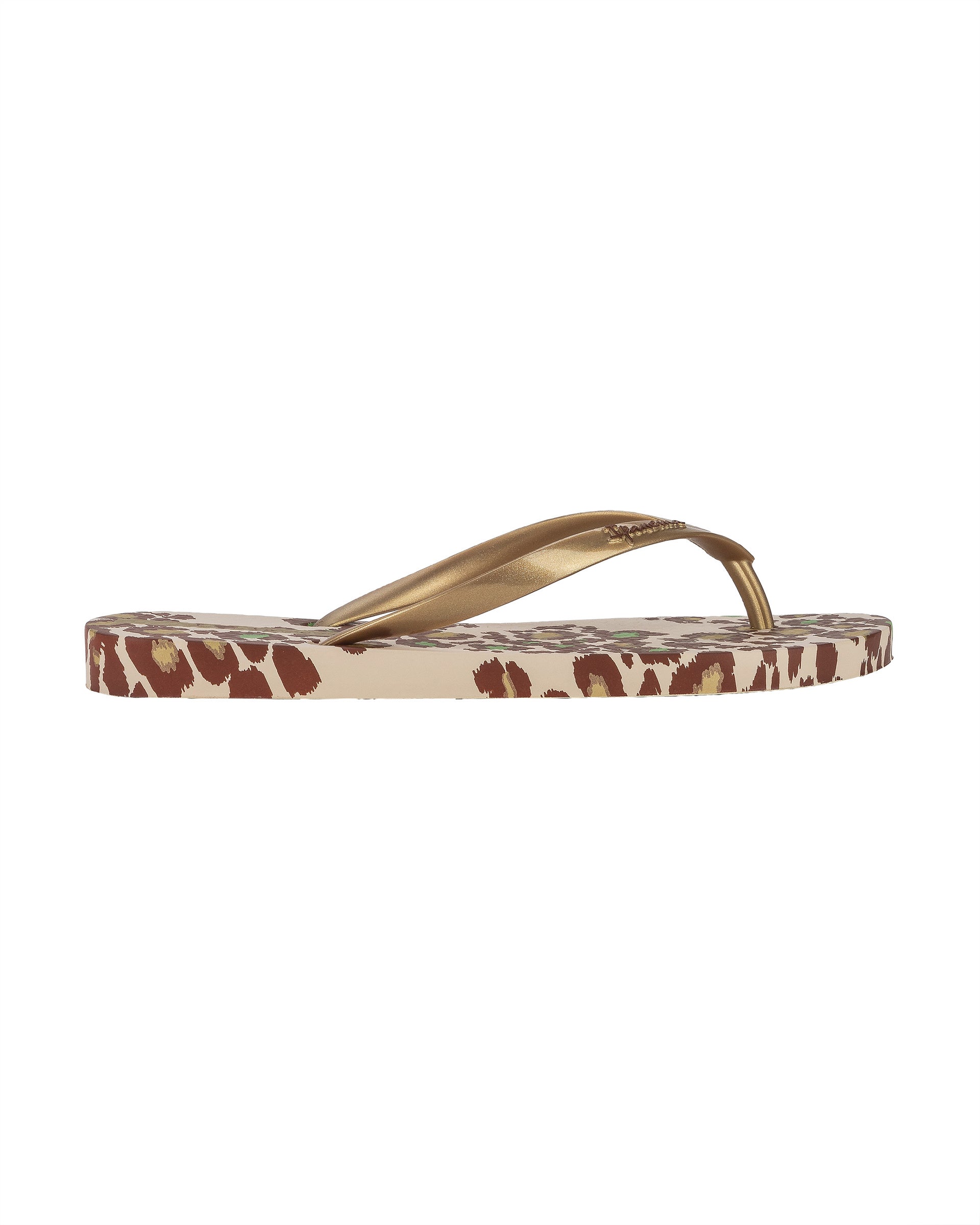 Outer side view of a beige Ipanema Animal Print women's flip flop with glitter gold straps and leopard sole print.