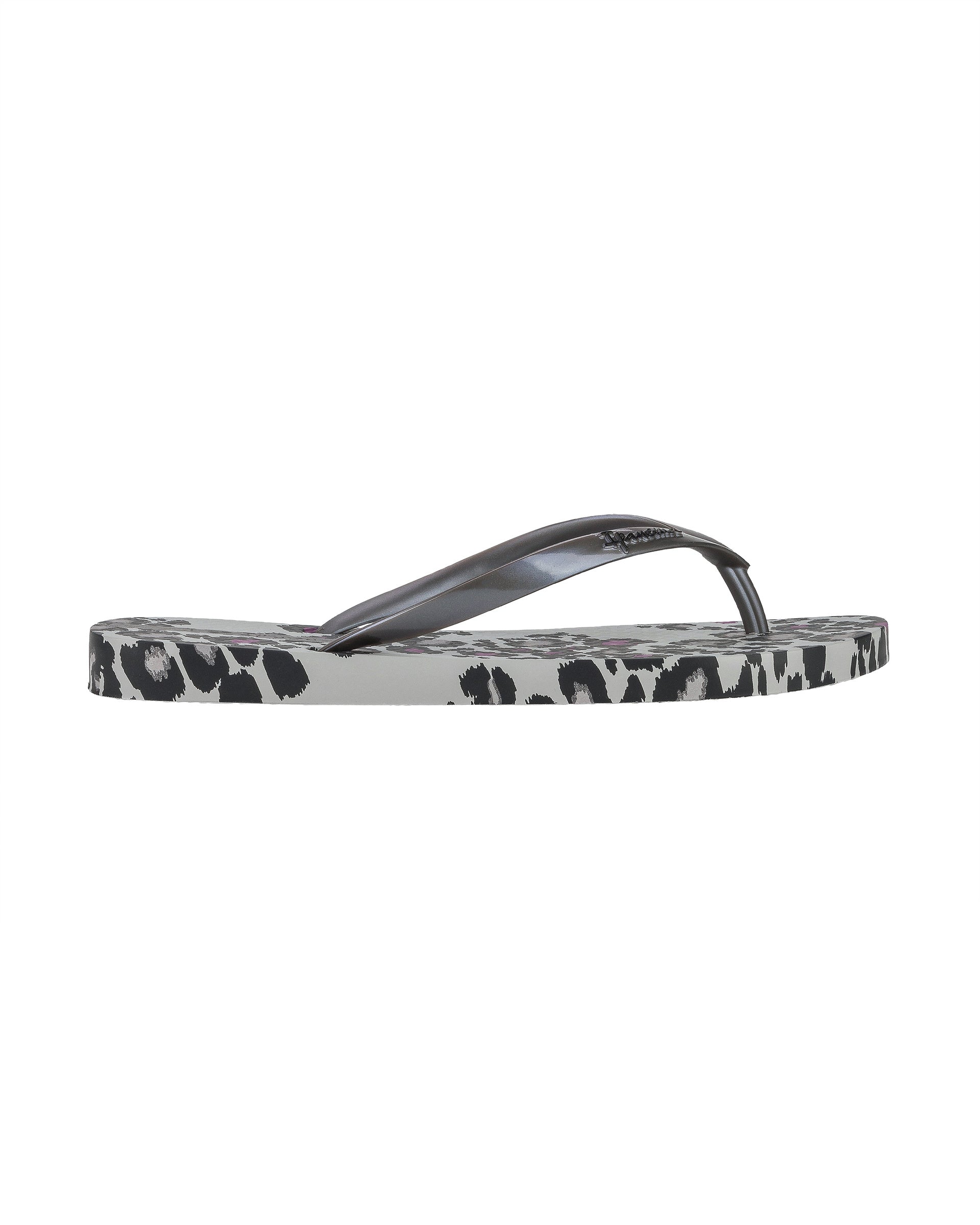 Outer side view of a grey Ipanema Animal Print women's flip flop with glitter grey straps and leopard sole print.