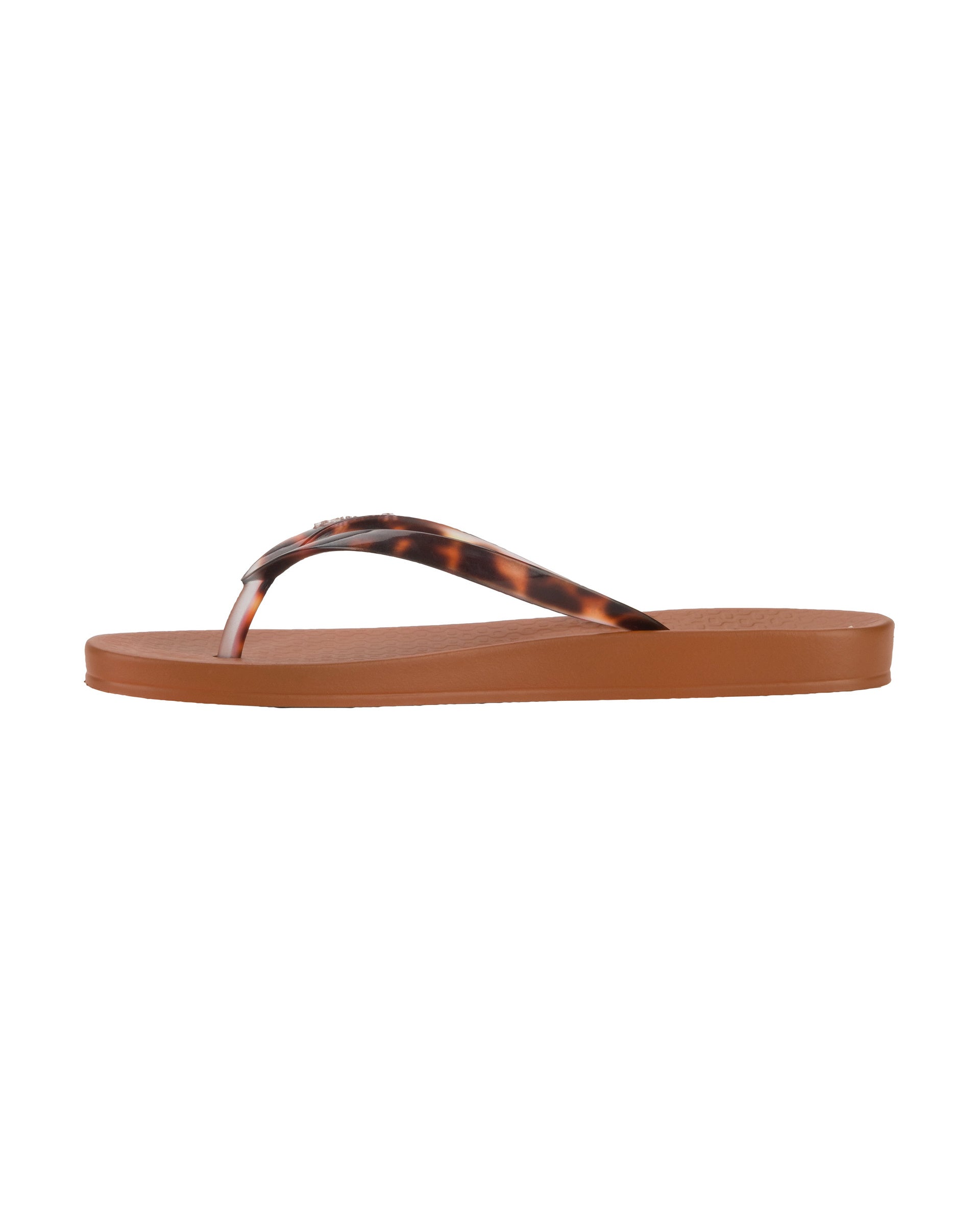 Inner side view of a brown Ipanema Ana Connect women's flip flop with brown tortoiseshell  color strap.