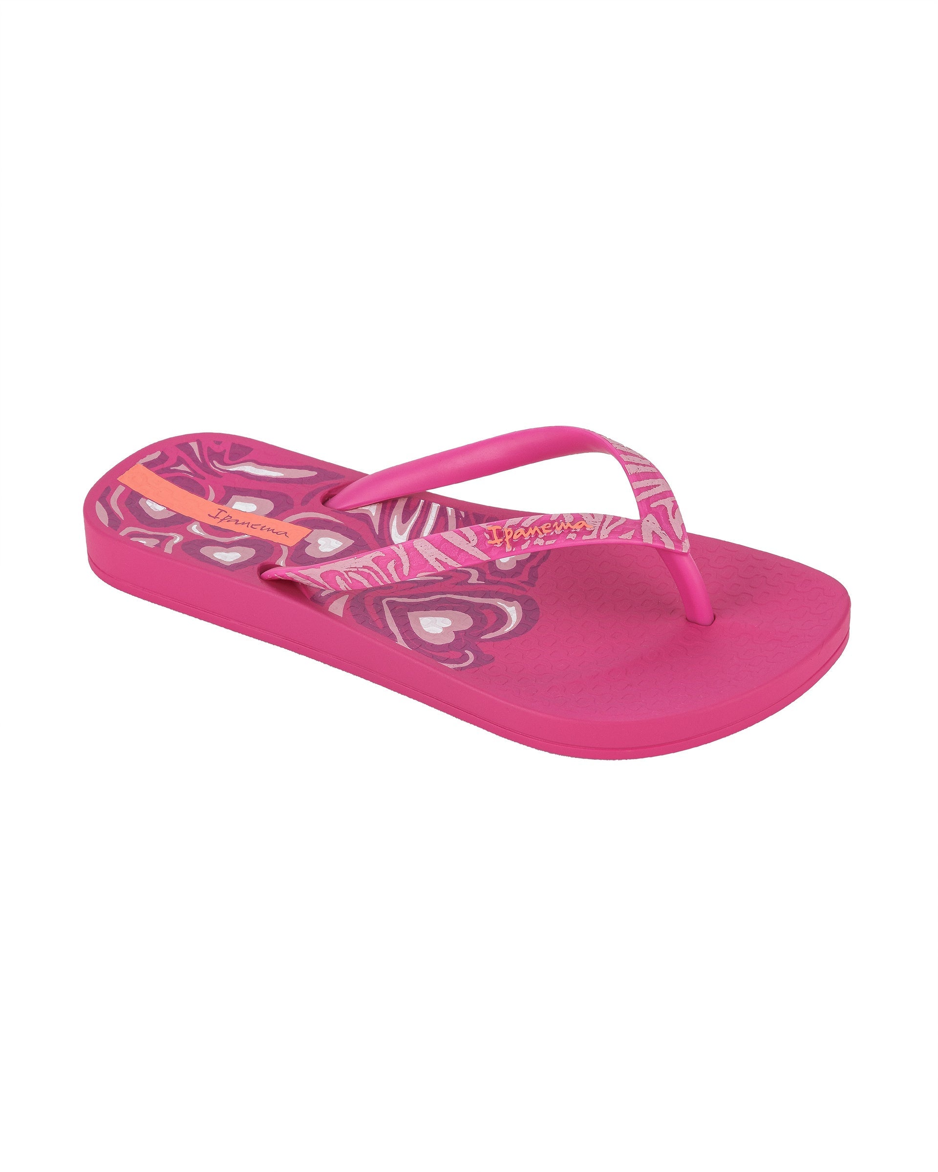 Angled view of a pink Ipanema Nostalgic Hearts kid's flip flop with heart outlines on insole and strap.