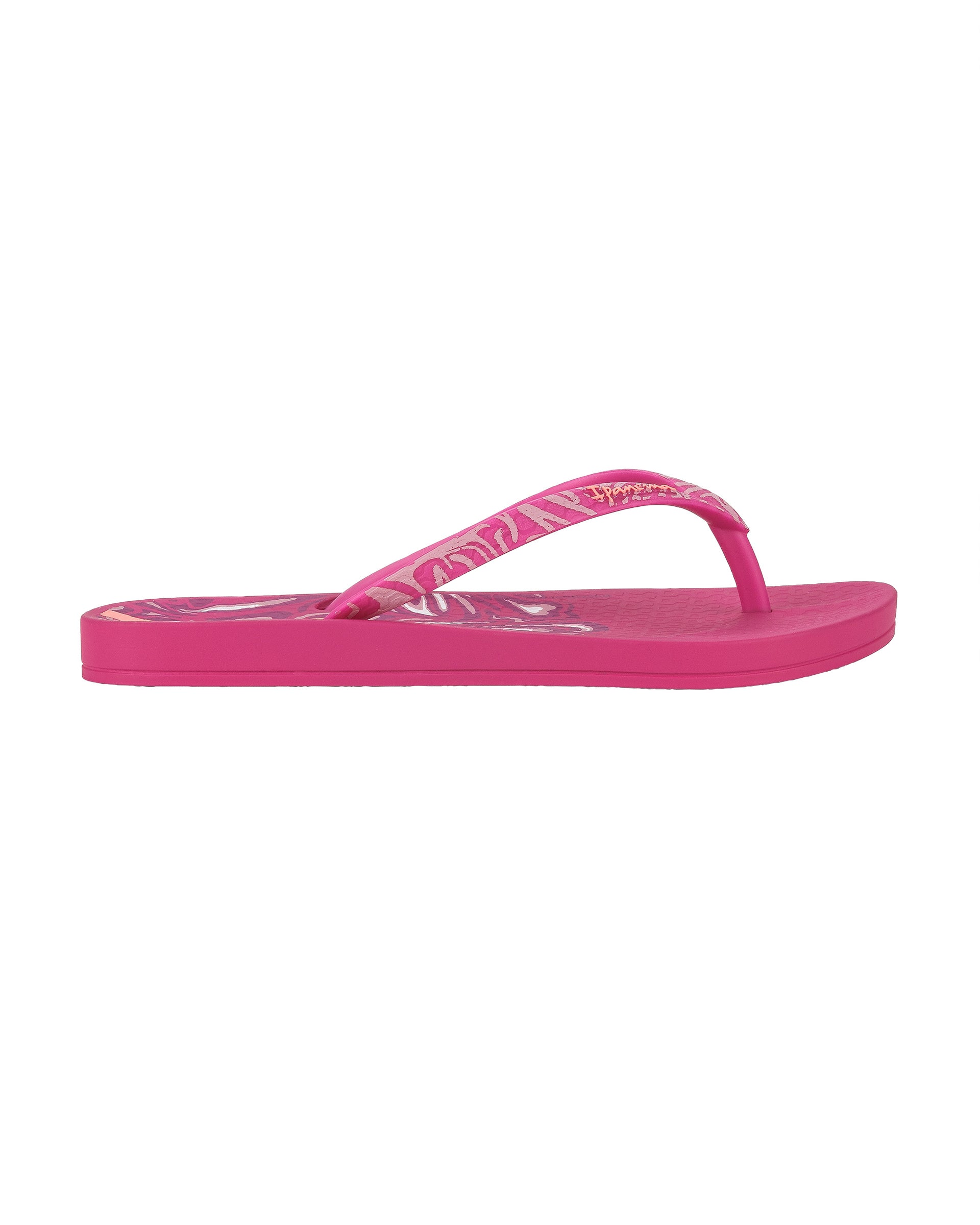 Outer side view of a pink Ipanema Nostalgic Hearts kid's flip flop with heart outlines on insole and strap.