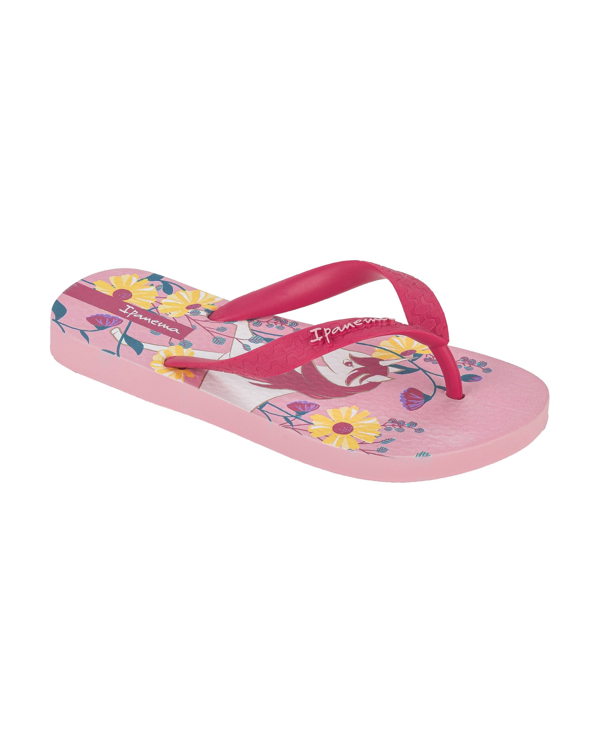 Angled view of a pink Ipanema Temas kids flip flop with unicorn and flower print.