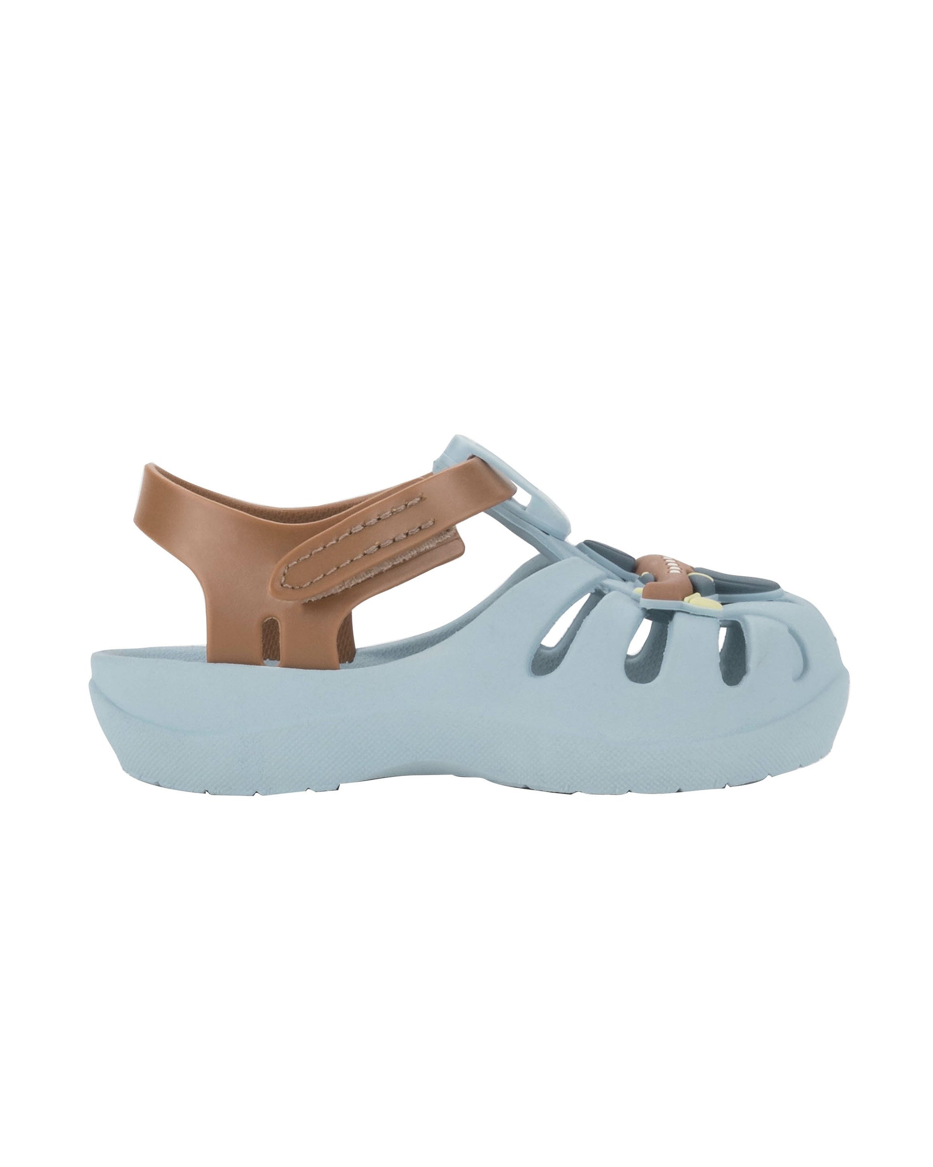 Outer side view of a blue Ipanema Summer baby sandal with airplane on the upper and a brown strap.