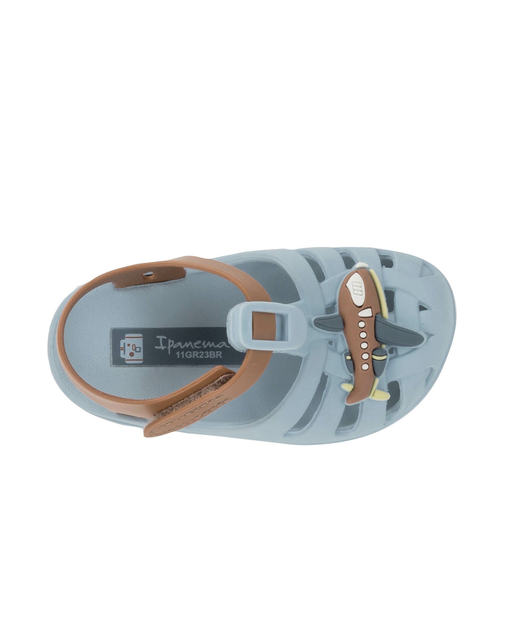 Top view of a blue Ipanema Summer baby sandal with airplane on the upper and a brown strap.