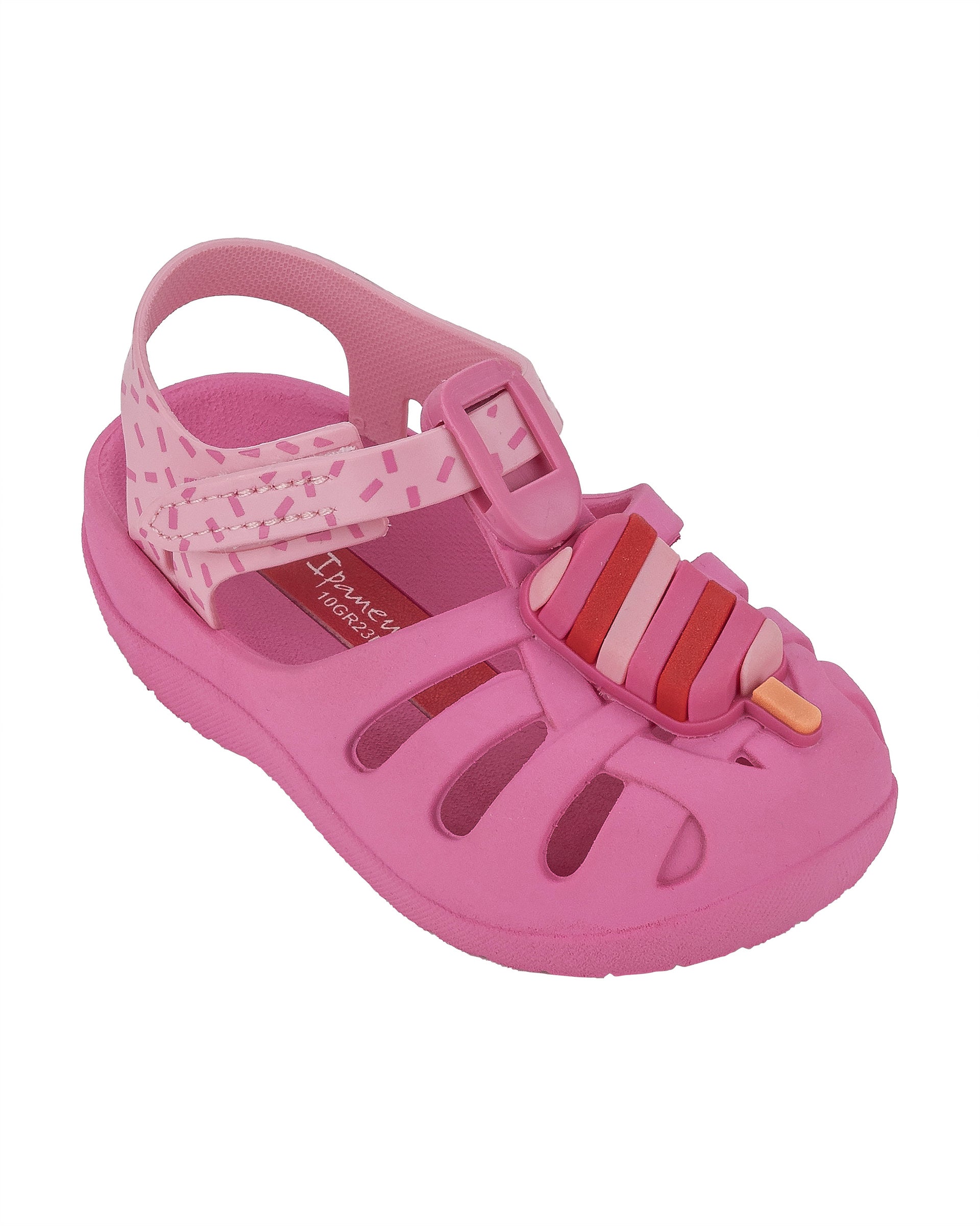 Angled view of a pink Ipanema Summer baby fisherman sandal with a popsicle on the upper.