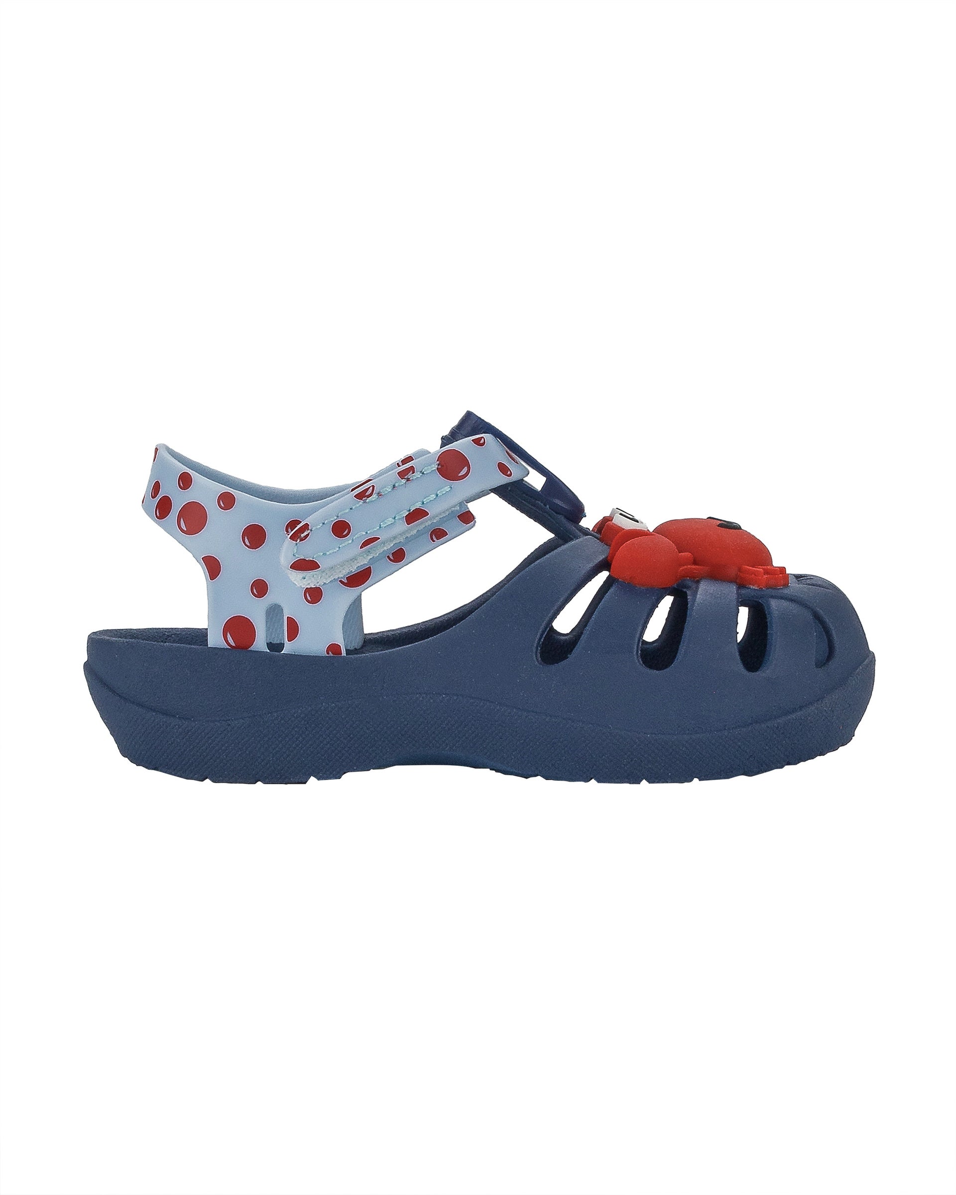 Outer side view of a blue/light blue Ipanema Summer baby fisherman sandal with red crab on the upper.