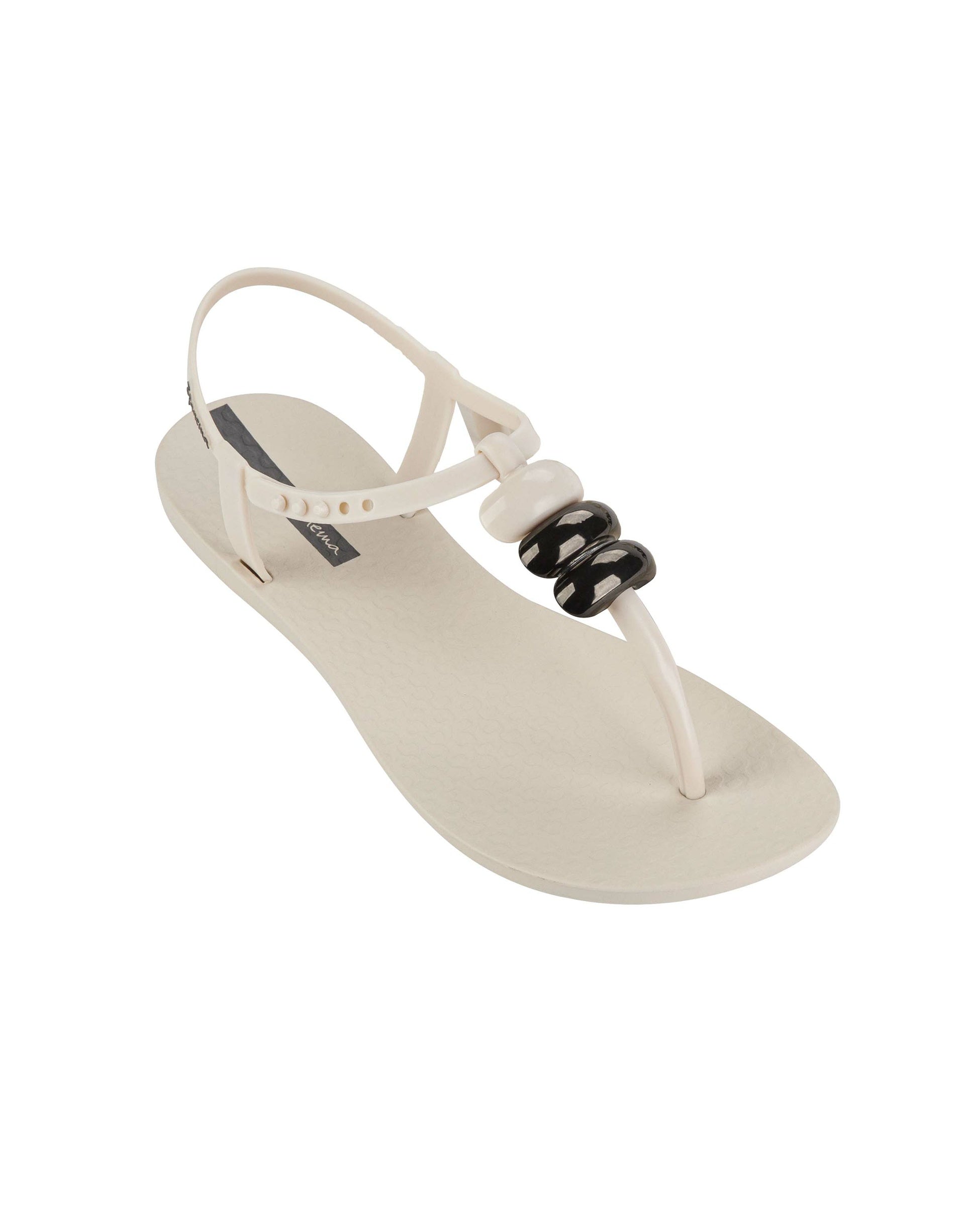 Angled view of a beige Ipanema Class women's sandal with 3 bubble baubles on the t-strap.