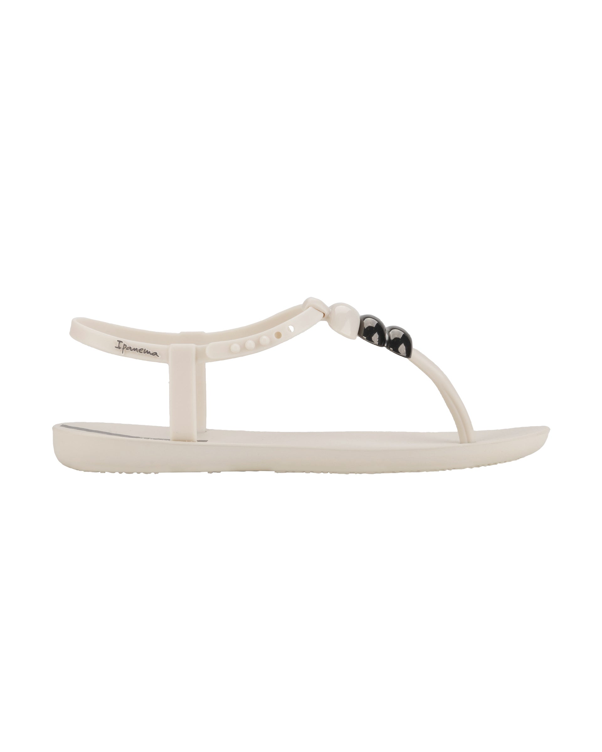 Outer side view of a beige Ipanema Class women's sandal with 3 bubble baubles on the t-strap.